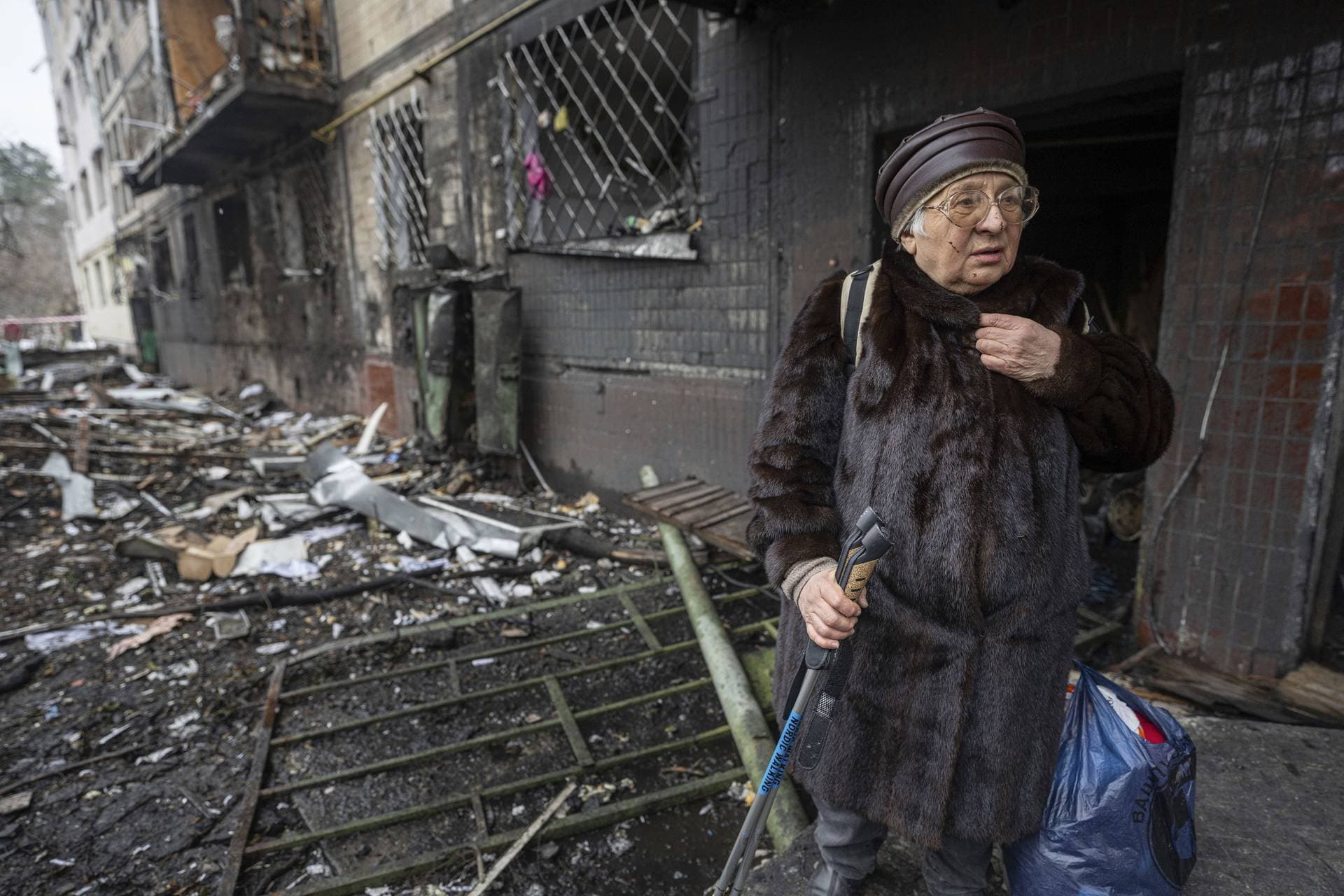 Svitlana Magdenko stands in front of her damaged house after a Russian rocket attack at a residential neighbourhood in Kyiv