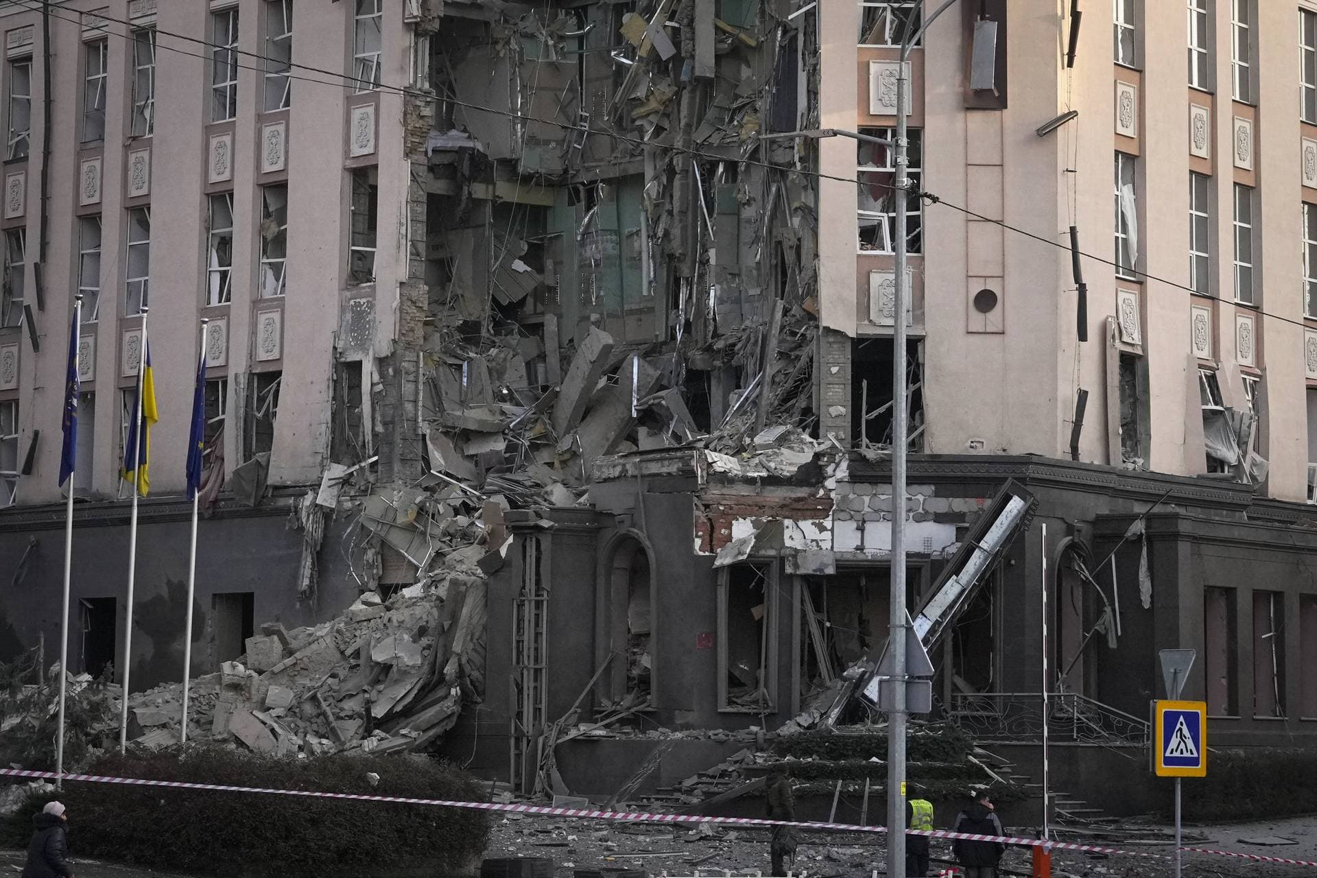 Police stand in front of damaged hotel at the scene of Russian shelling in Kyiv