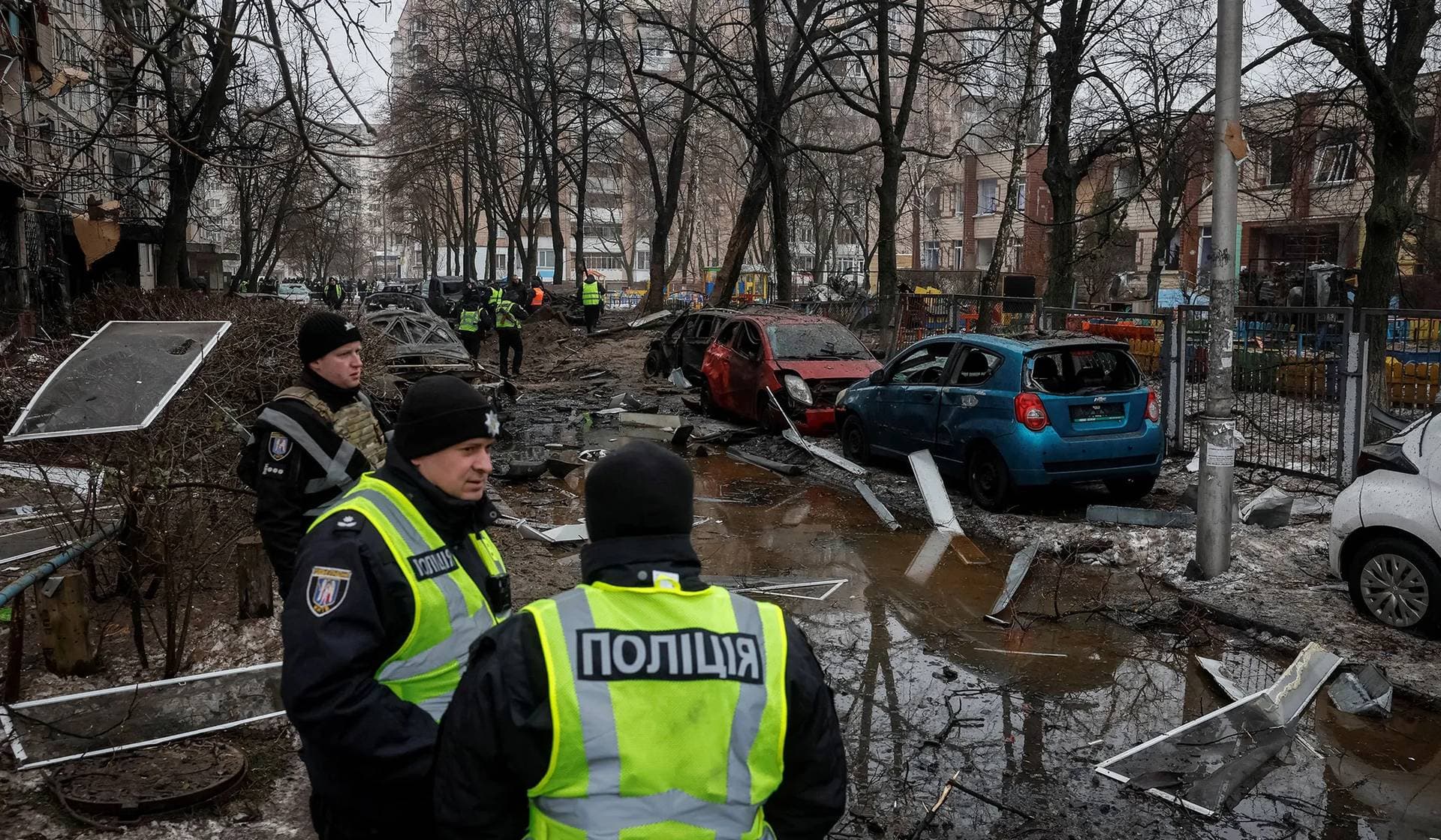 Police guard a site where an apartment building damaged during a Russian missile strike in Kyiv
