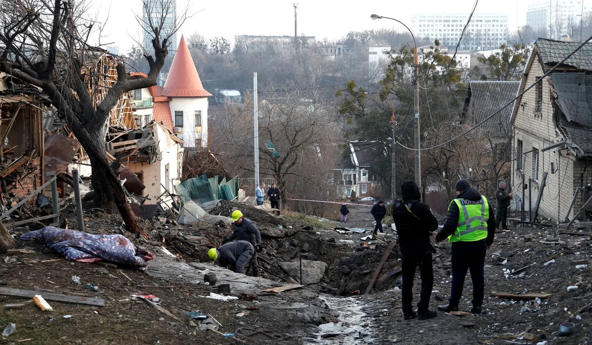 Police officers stand at a site of a Russian missile strike in Kyiv