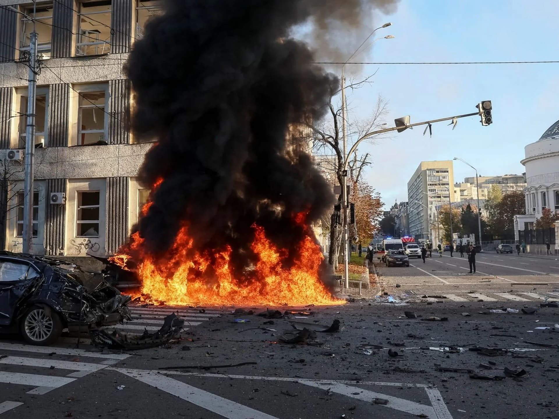Cars burn after a Russian military strike in central Kyiv