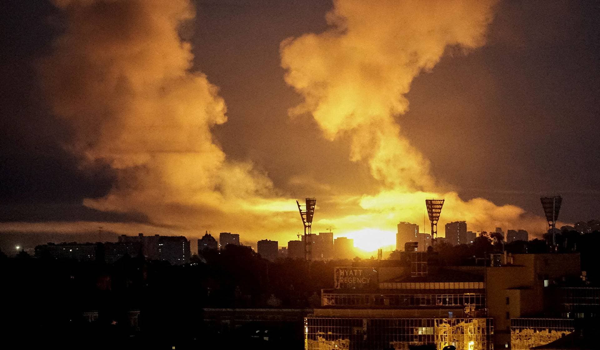 An explosion lights up the sky over the city during a Russian missile and drone strike in Kyiv