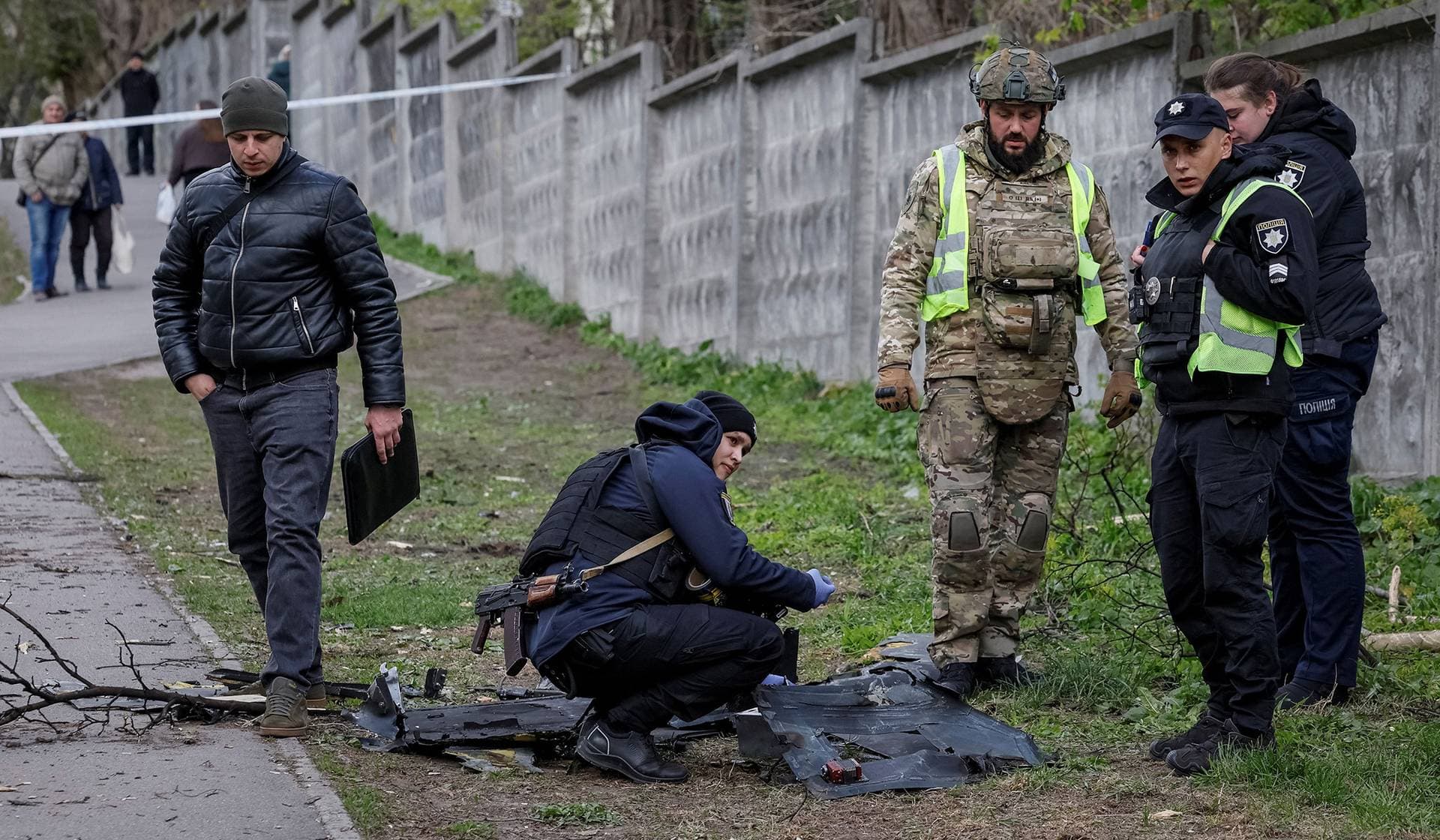 A police expert works at the site of a Russian drone strike in Kyiv