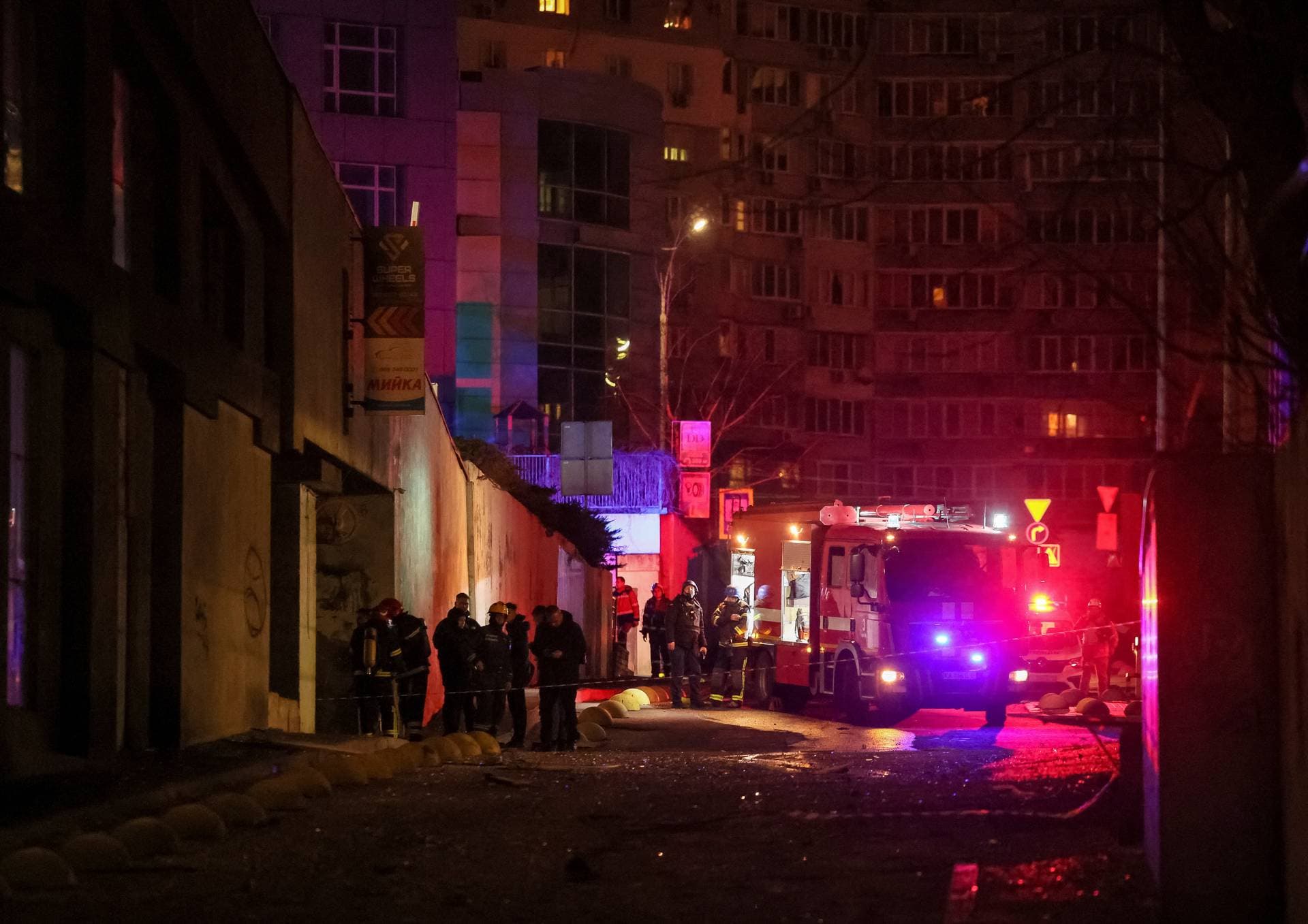 Emergency staff work at a site of an apartment building damaged during a Russian drone strike in Kyiv