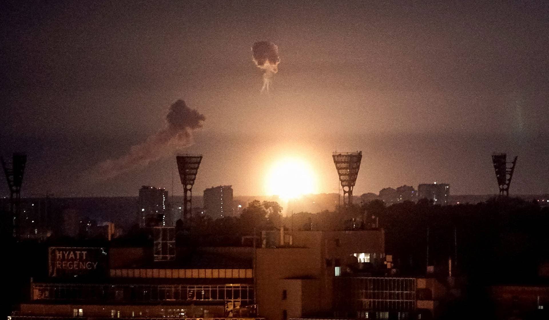 An explosion lights up the sky over the city during a Russian missile and drone strike in Kyiv