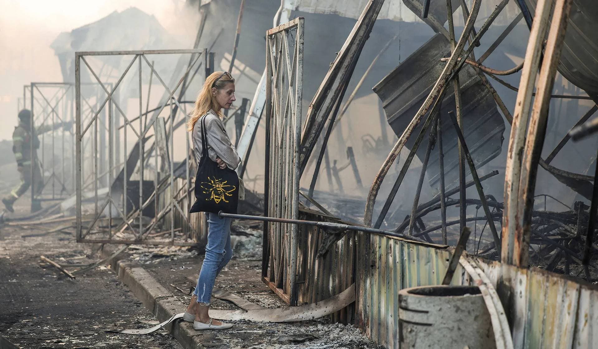 A resident observes a market damaged during Russian missile and drone strike in Kyiv