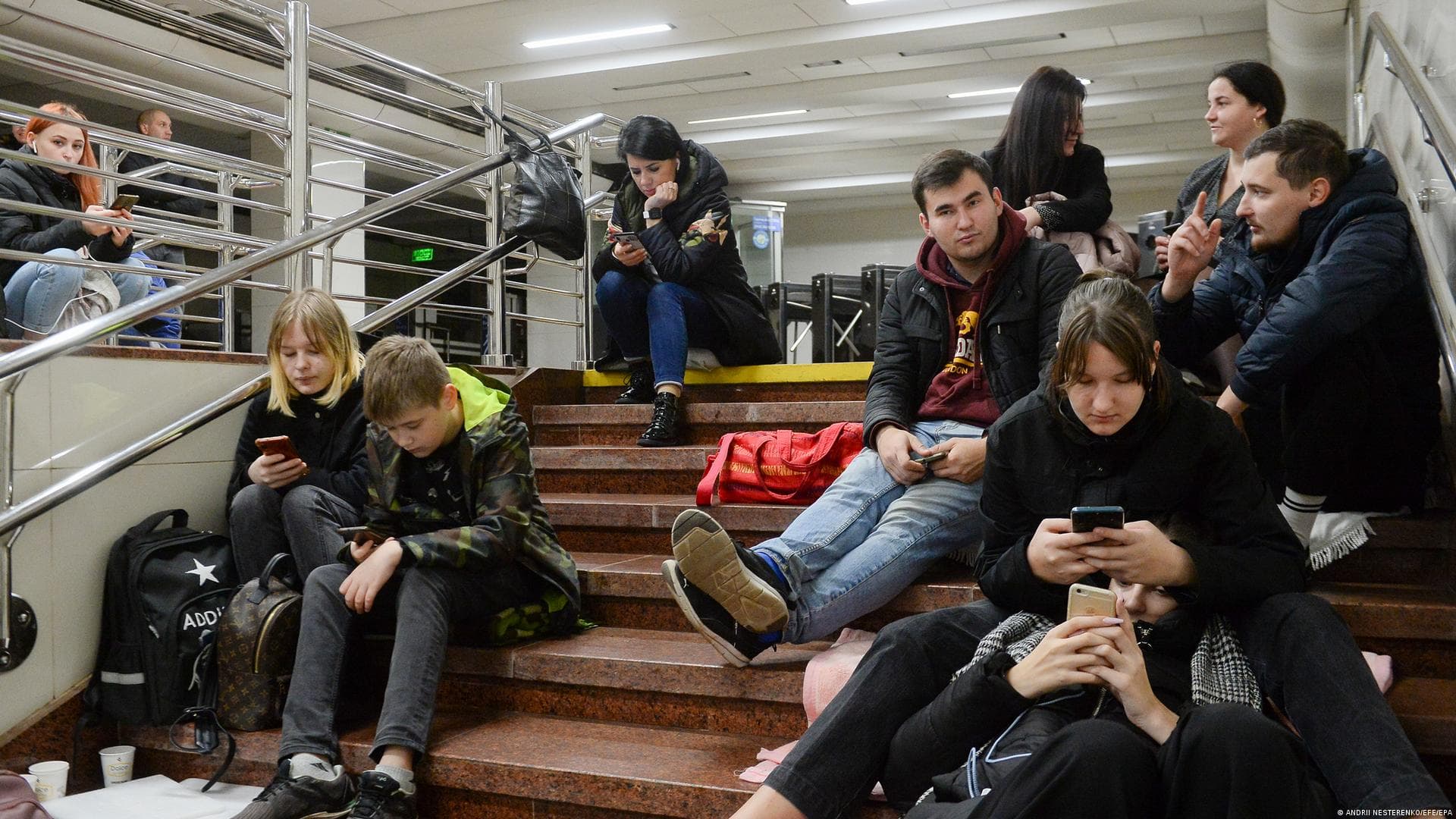 People in the Ukrainian capital sheltered inside metro stations, checking for updates as the city came under renewed shelling on Monday