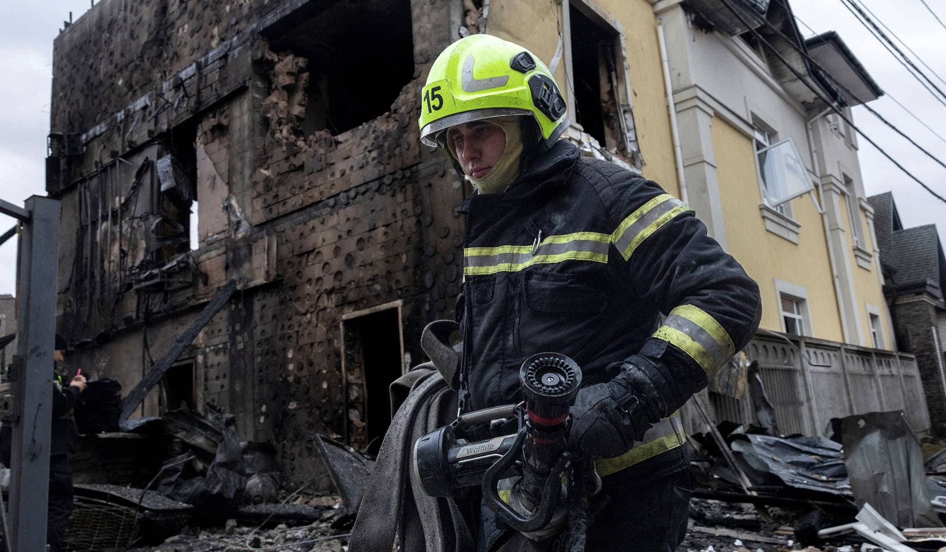 A firefighter walks at the site where a Russian drone struck a residential building during a night of Russian drone and missile attacks in Kyiv