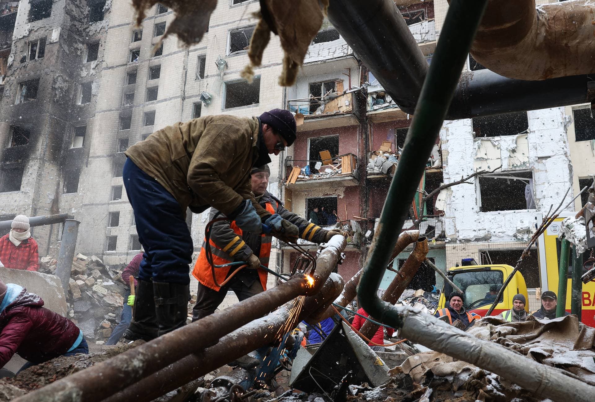 Utility workers repair water pipes hit in a Russian missile attack on Kyiv.