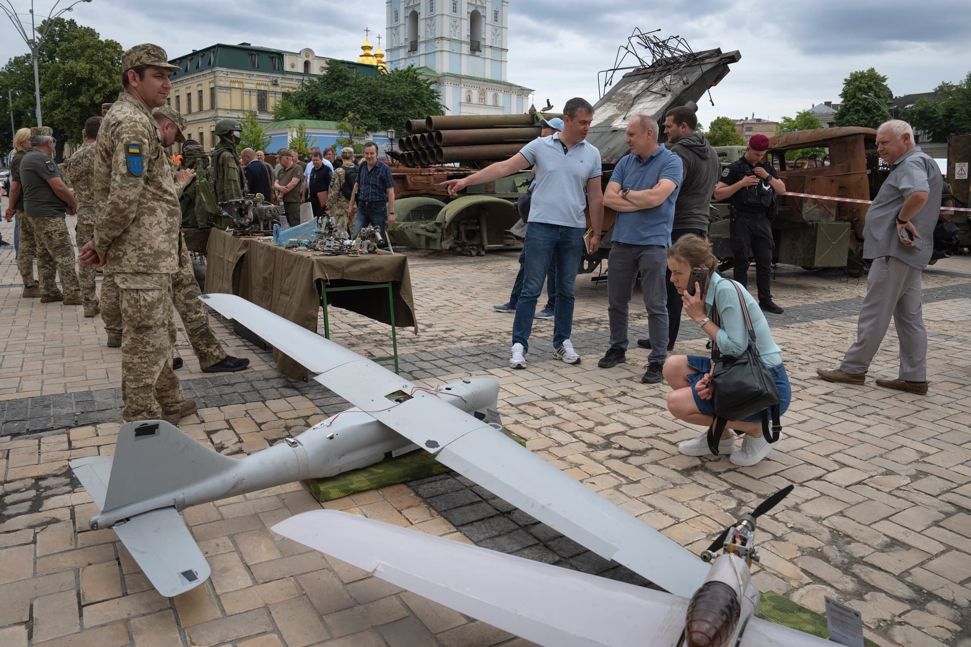 People look at Russian drones installed as a symbol of war in central Kyiv