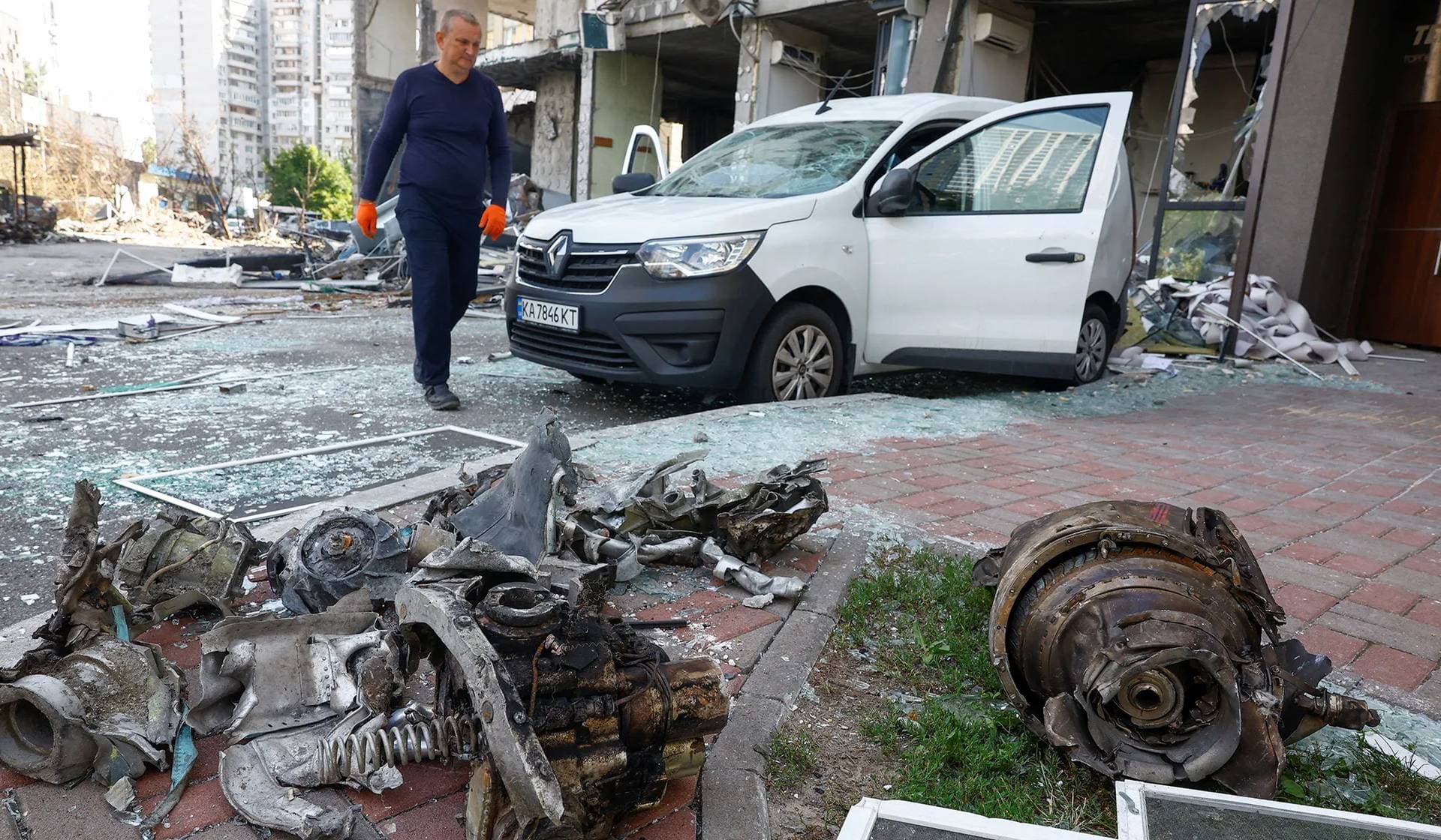 A man walks next to remains of a Russian cruise missile which hit an apartment building and killed 11 people during a missile strike on the previous day, according to State Emergency Service in Kyiv, Ukraine, July 7, 2026.