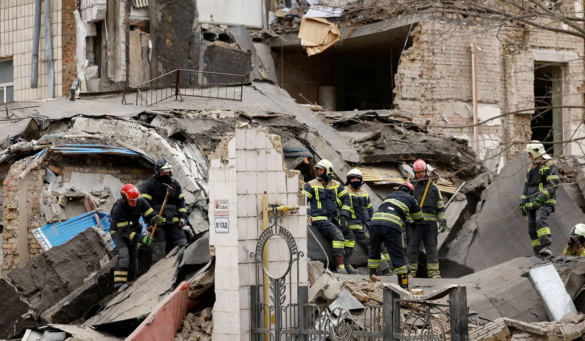 Rescuers work at the site of a building damaged by a Russian missile strike in Kyiv