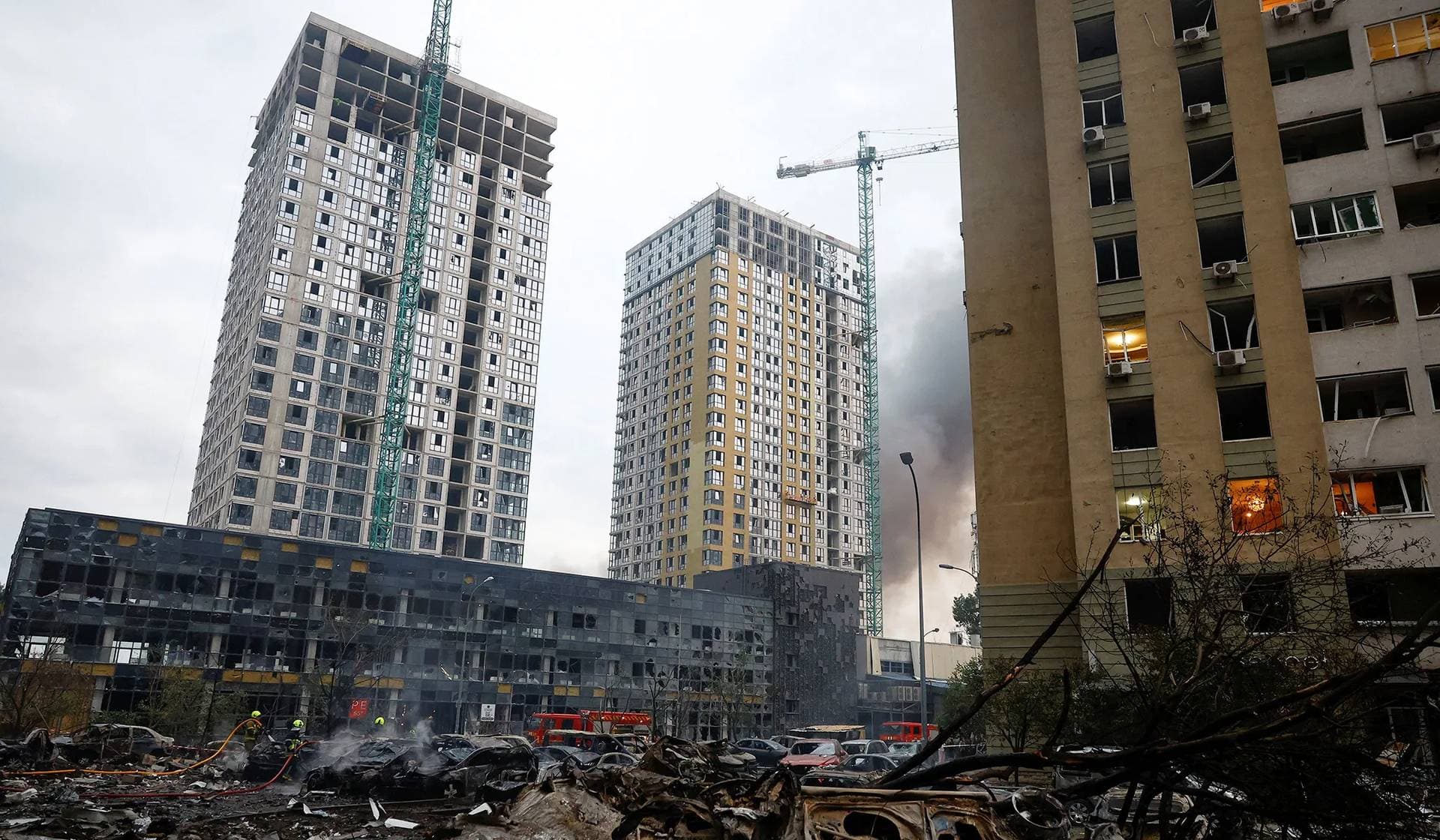 Firefighters work at the site of an apartment building heavily damaged during Russian missile and drone strikes in Kyiv