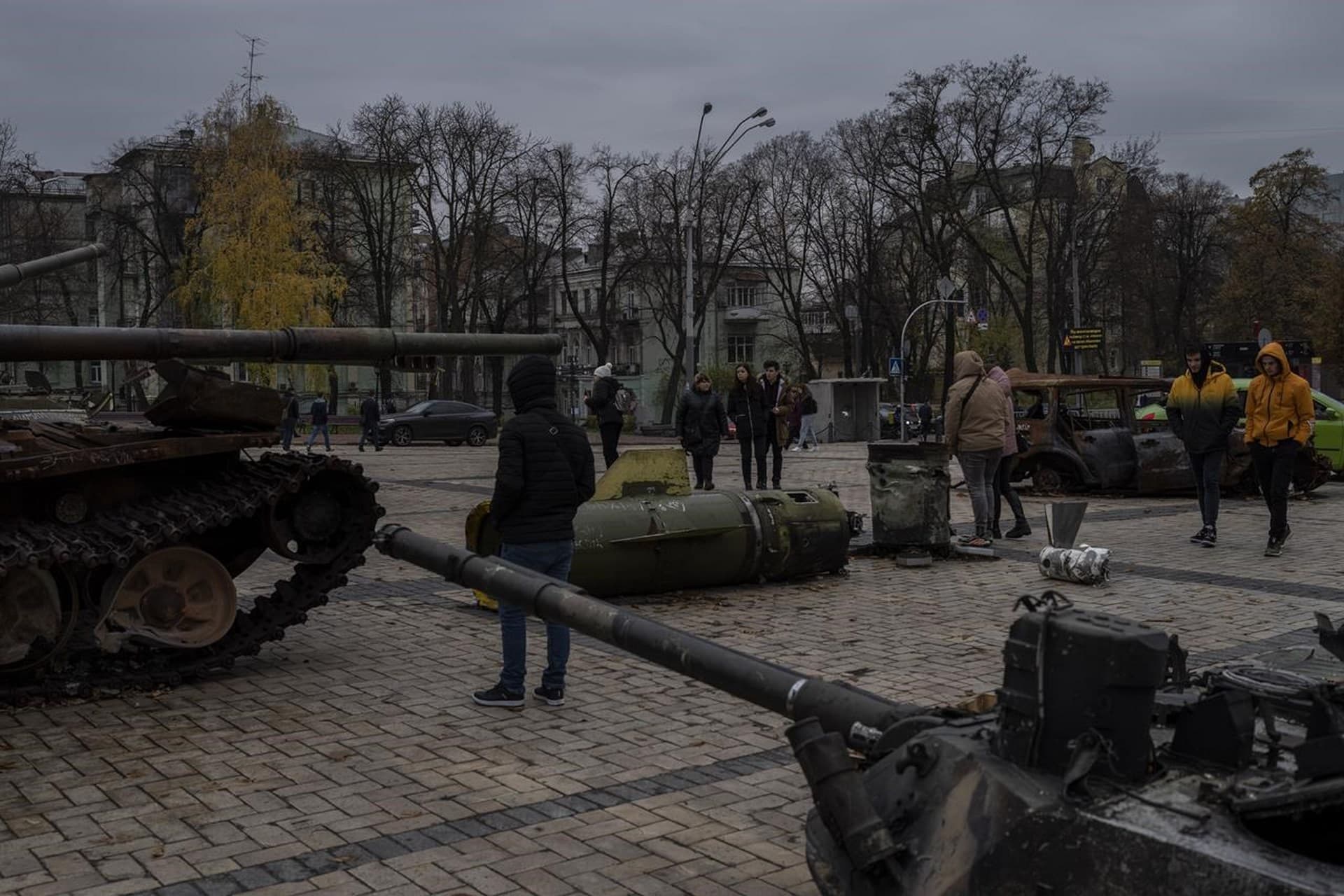 Pedestrians walk past a display of destroyed Russian tanks and armoured vehicles in Kyiv
