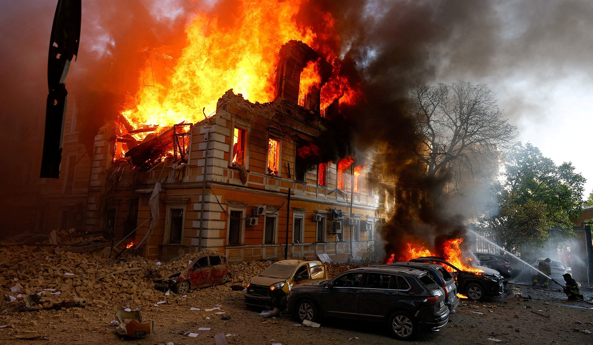 Smoke and flames rise from an administrative building hit by a Russian jet-powered drone strike in Kyiv