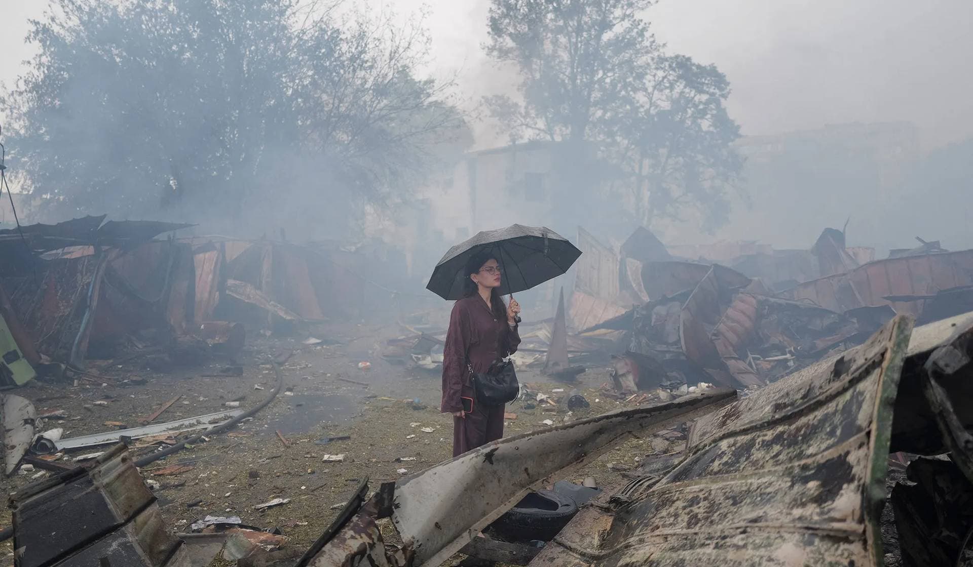 A resident stands at a site of a Russian missile and drone strikes on the outskirts of Kyiv