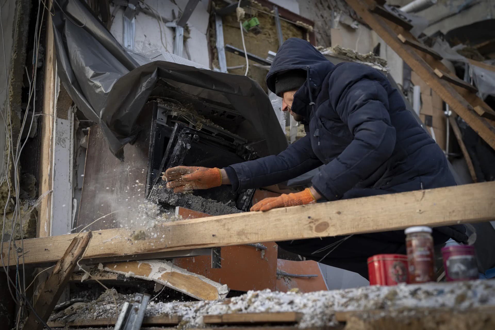 Serhii Kaharlytskyi cleans the rubble in his ruined home in Kyiv