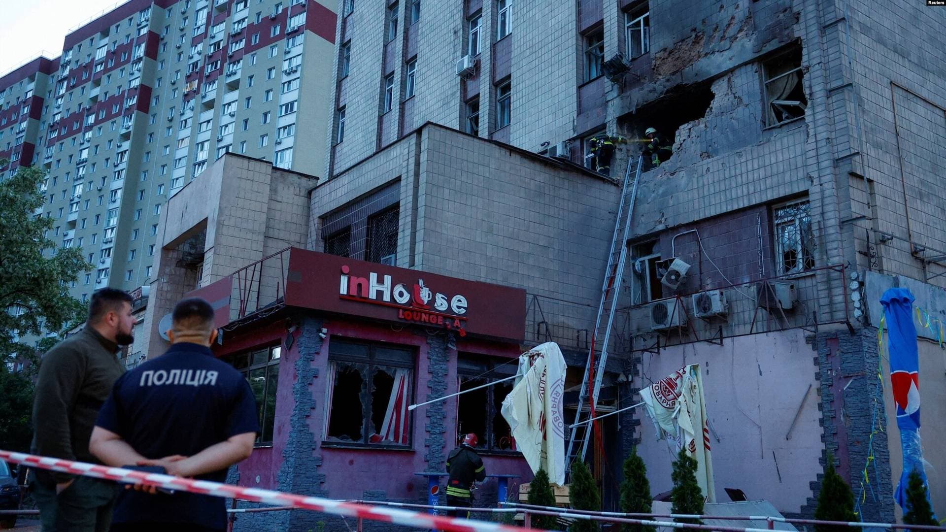 Rescuers work at the site of a building damaged during a Russian suicide drone strike in Kyiv