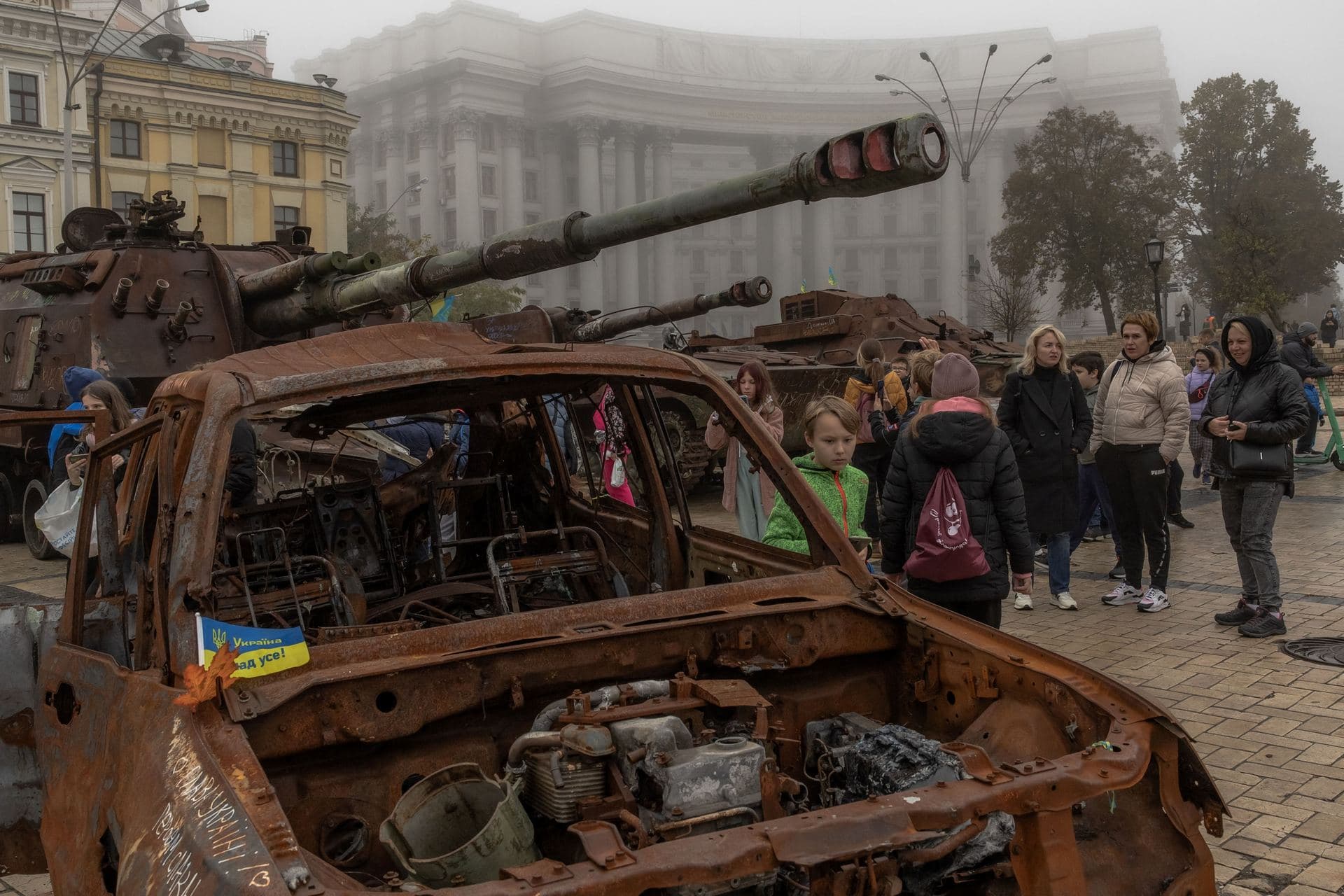 People look at destroyed Russian military vehicles on display in front of Saint Michael's Golden-Domed Monastery in Kyiv