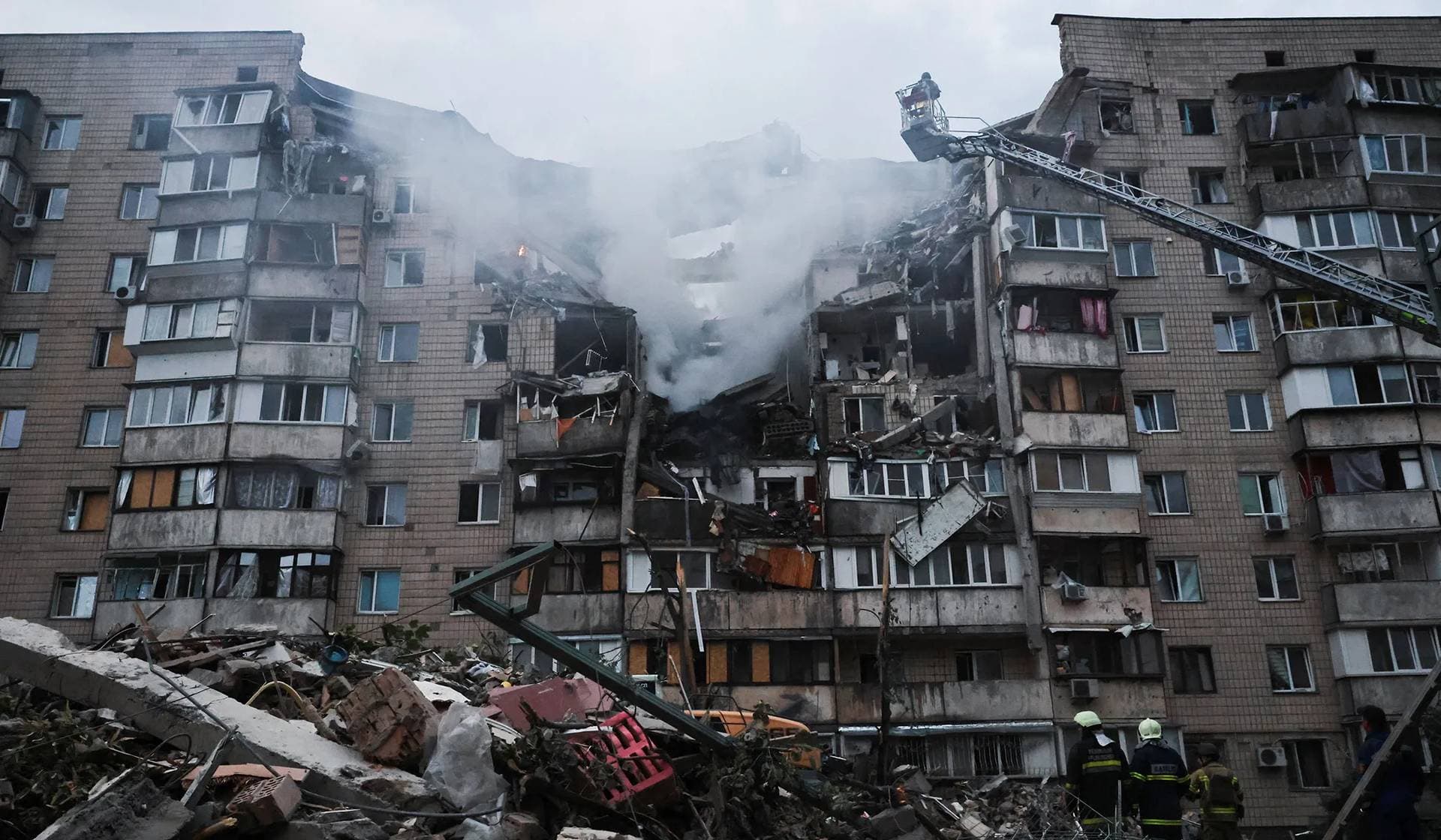 Rescuers work at the site of an apartment building which was heavily damaged during Russian missile and drone strikes in Kyiv