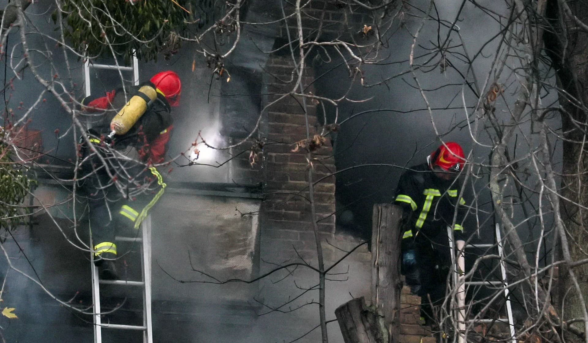 Firefighters work to put out a fire in a residential building hit by a Russian missile strike in Kyiv