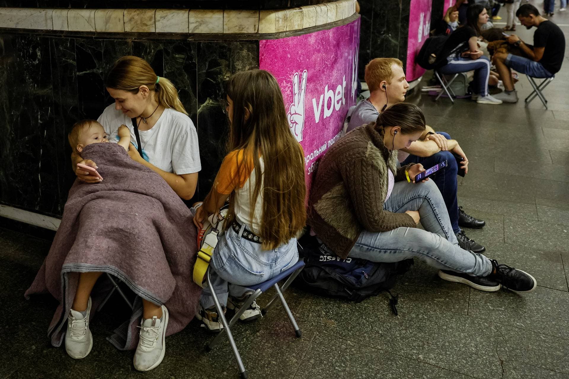 Woman breastfeeds Mark while they cover inside a subway station during an air raid alert, amid Russia's attack on Ukraine, in Kyiv