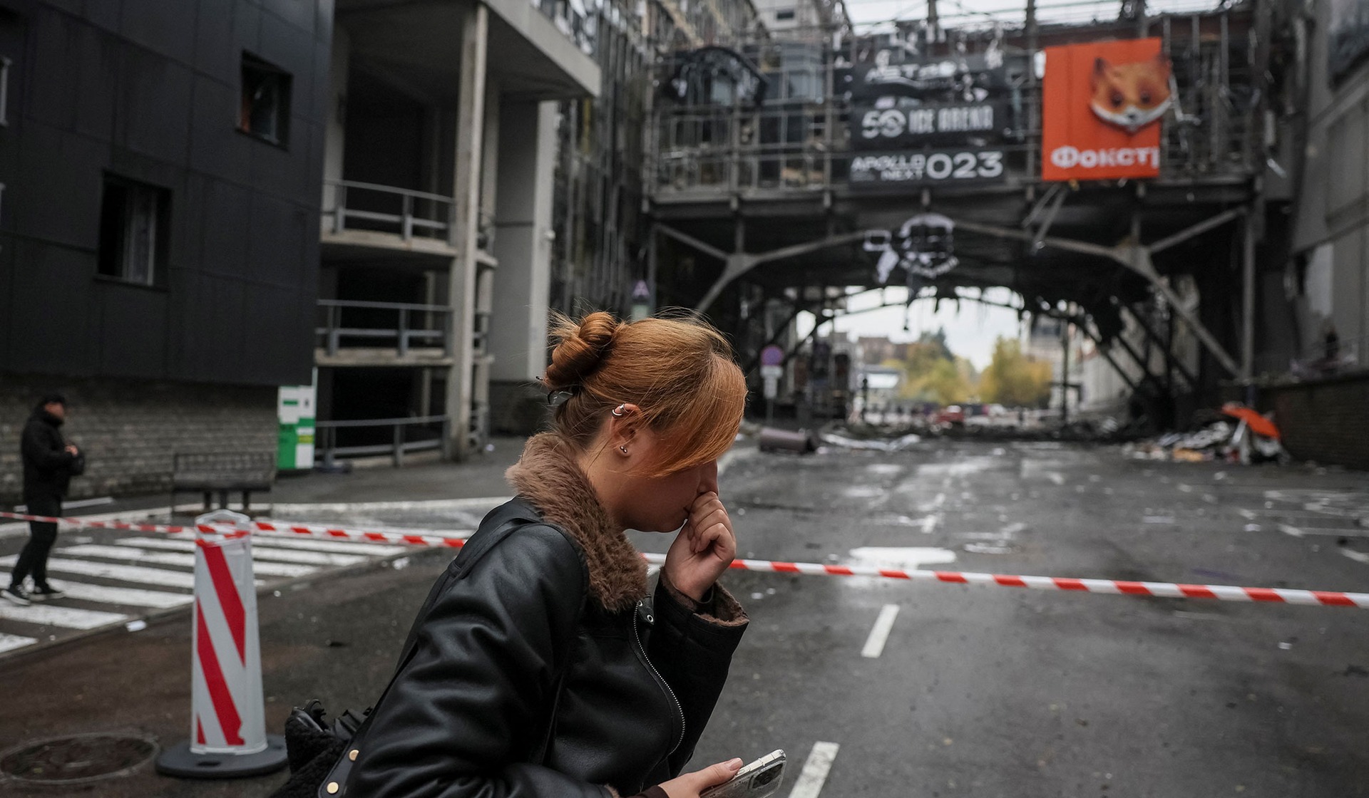 A residents walks at a site of a shopping mall in Kyiv