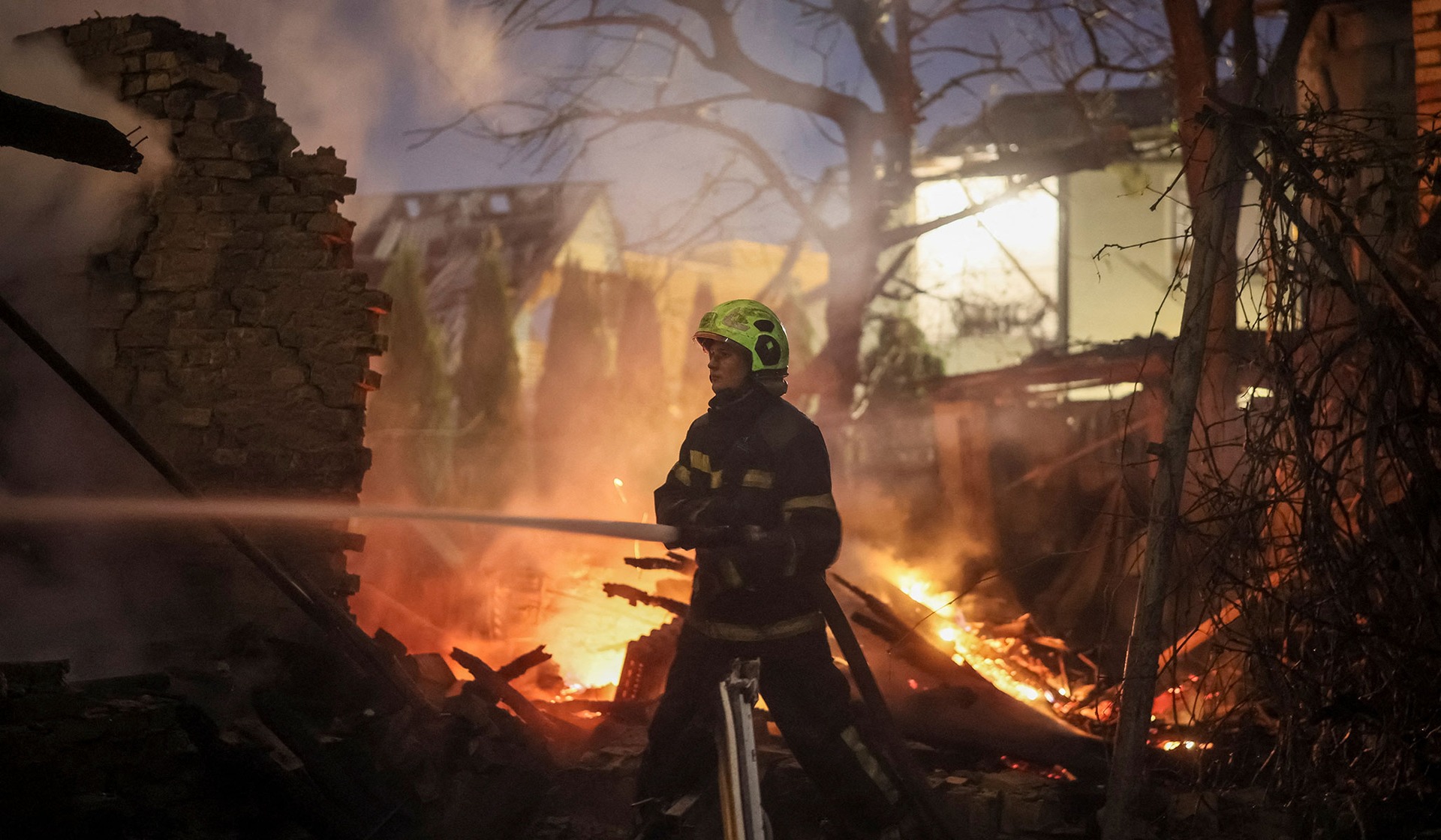 A firefighter works at the site of a private house hit by a Russian drone strike in Kyiv, Ukraine, September 30, 2026.