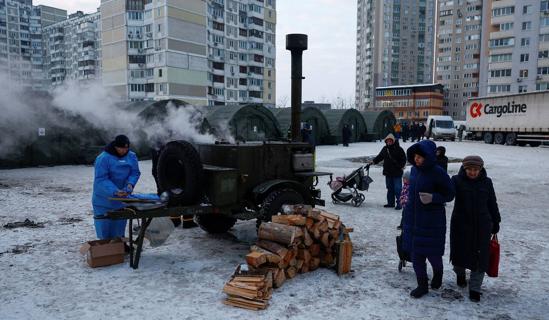 Employees remove debris at the site of a private hospital hit by Russian drone strikes in Kyiv