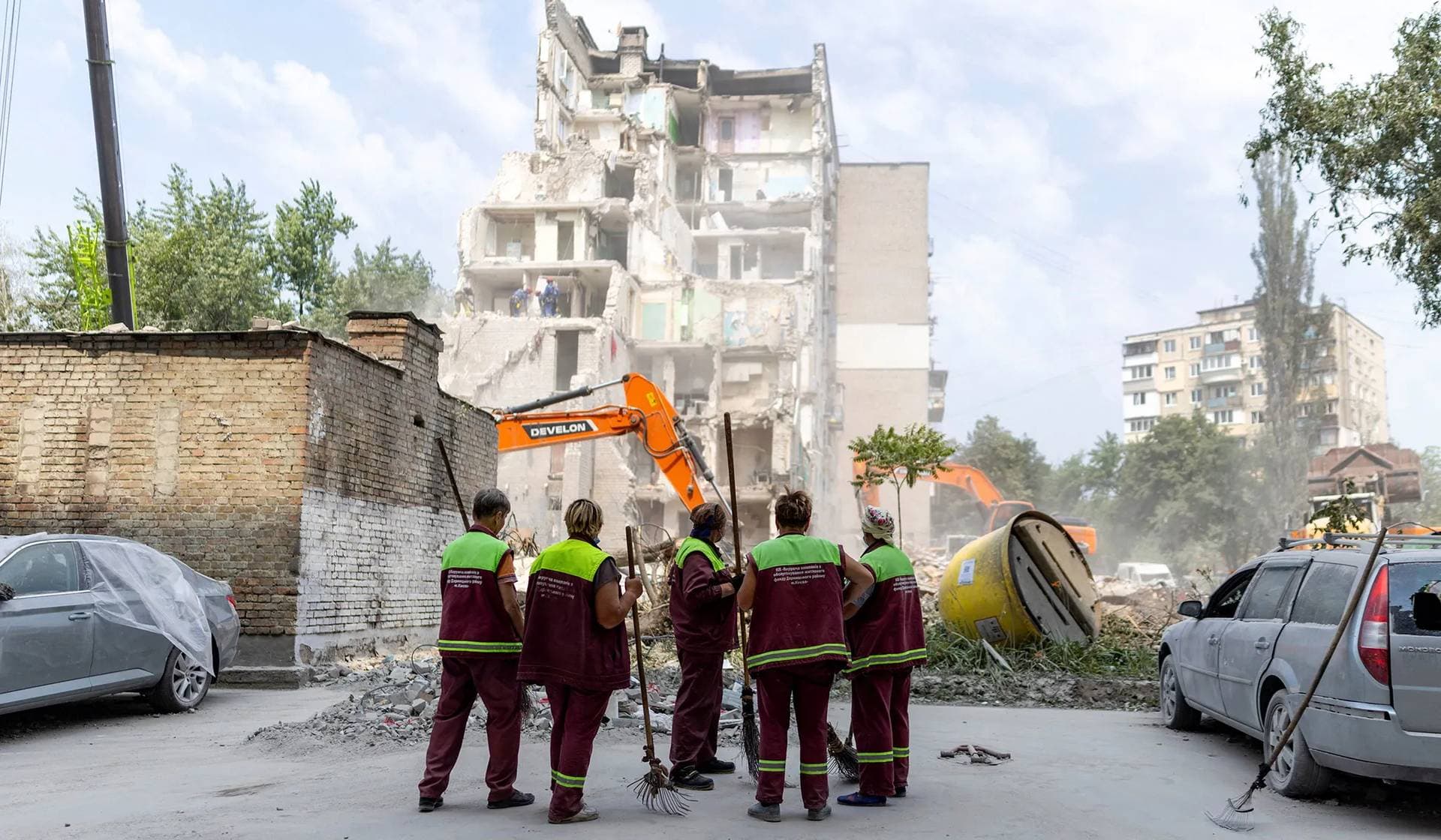 Municipality workers look at a residential building that was hit during Thursday’s Russian missile and drone attacks in Kyiv