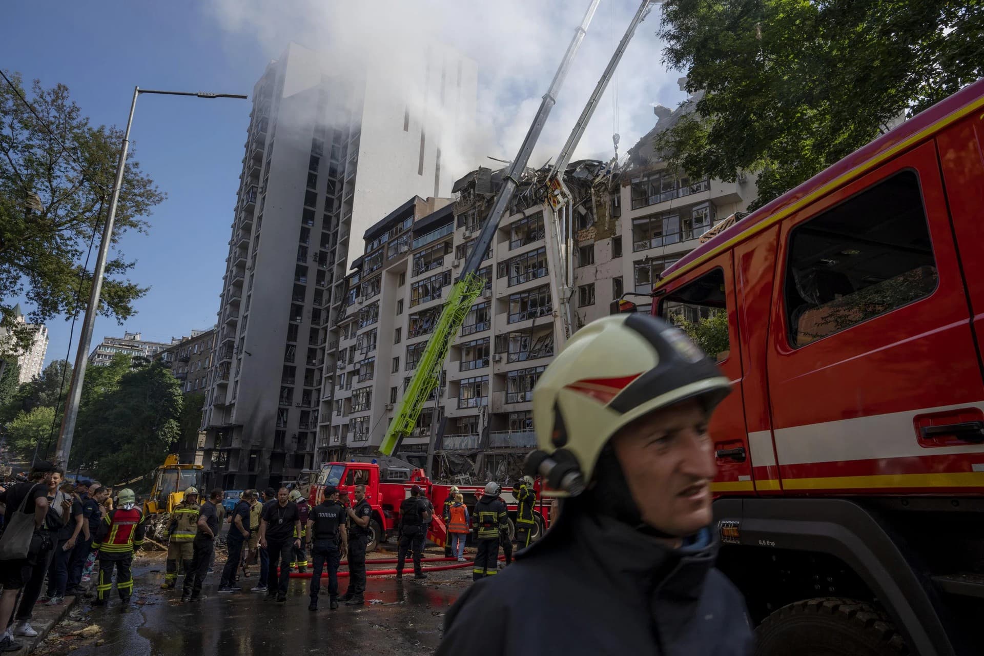Firefighters work at the scene of a residential building following explosions, in Kyiv