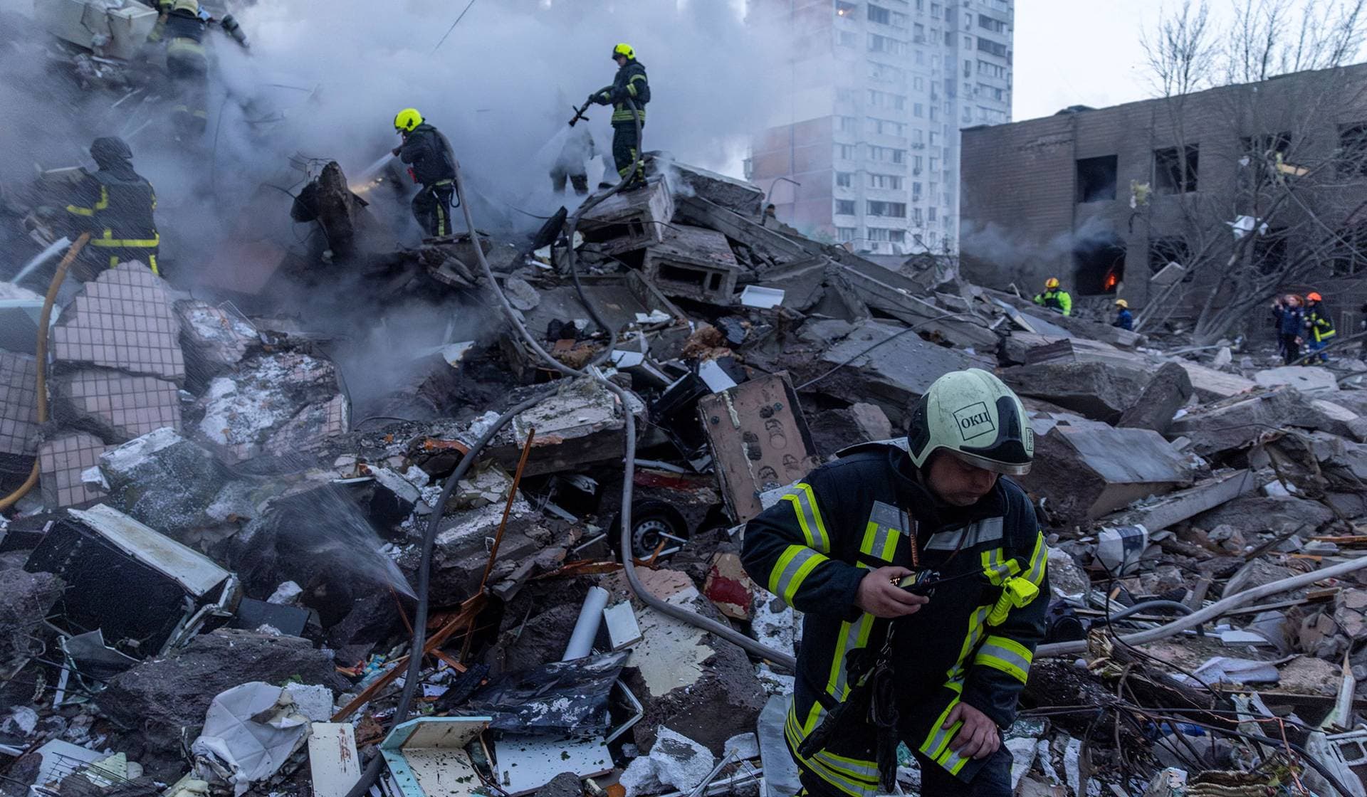 Rescuers search for people under the rubble of an apartment building damaged and partially collapsed during Russian missile and drone strikes in Kyiv
