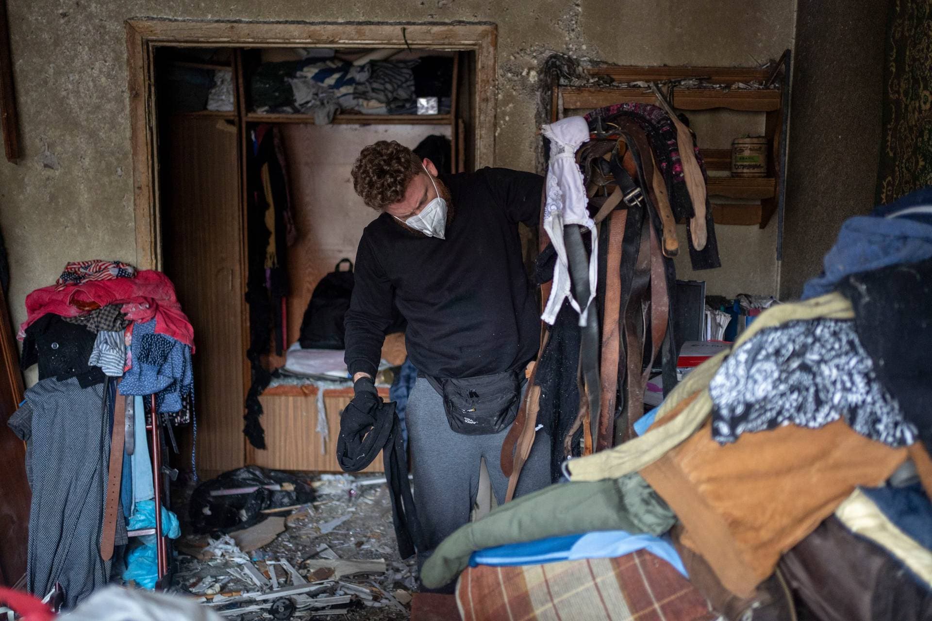 A man sorts out belongings at an apartment that was damaged as a result of Russia’s attack in Kyiv