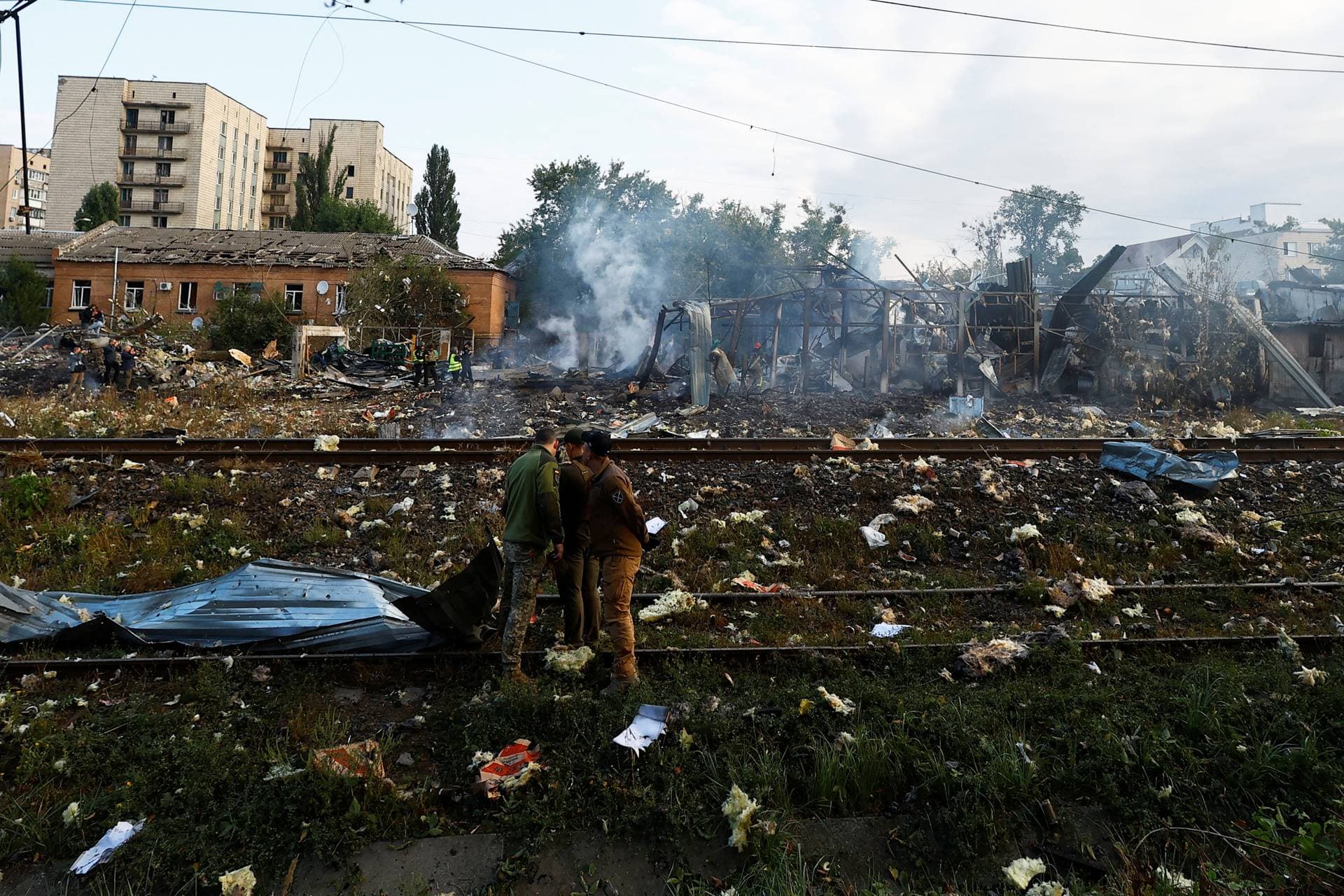 Emergency personnel examine debris at the still-smoking site in Kyiv