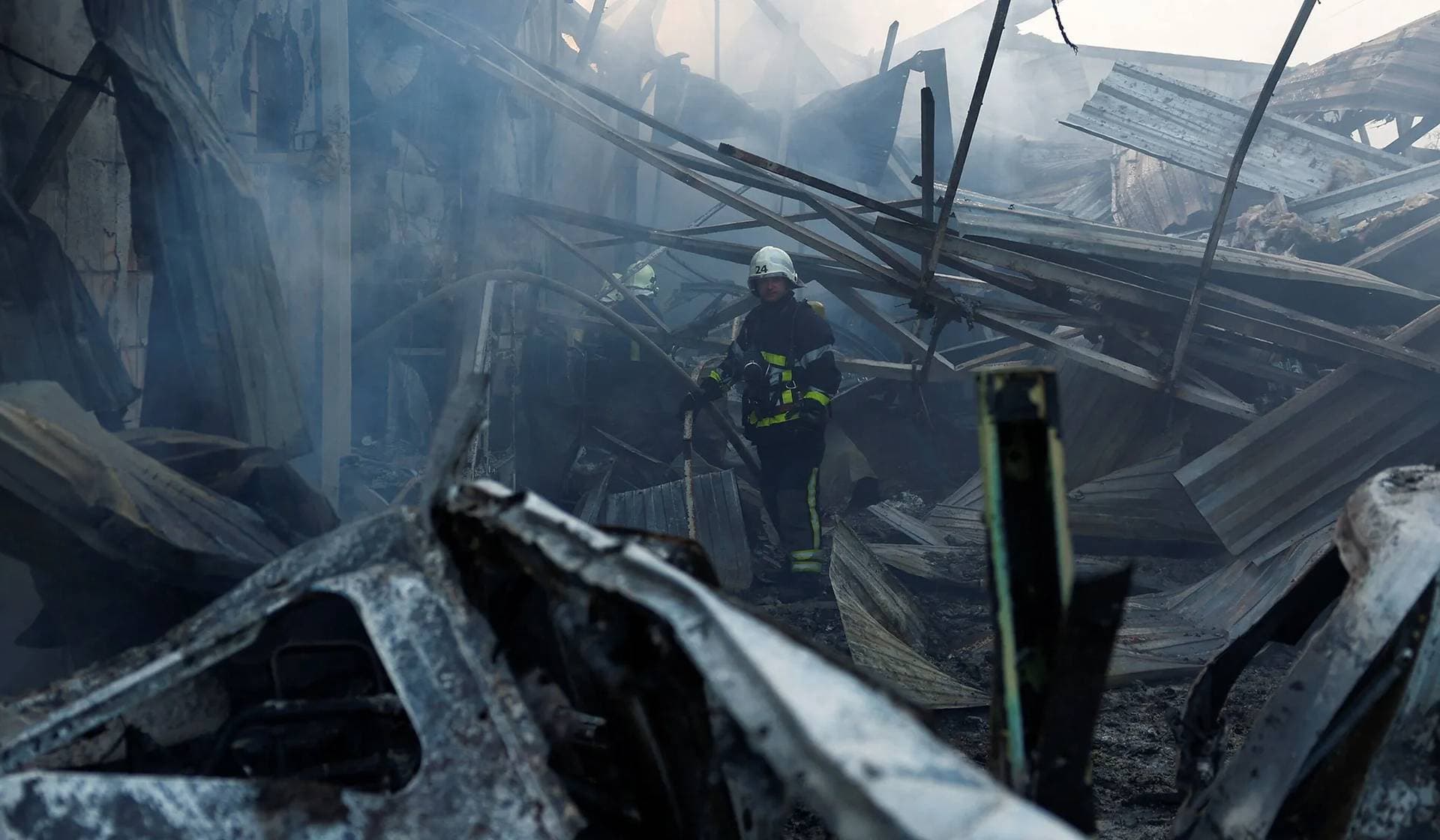 Firefighters work at a site in a residential area damaged during a Russian missile strike in Kyiv