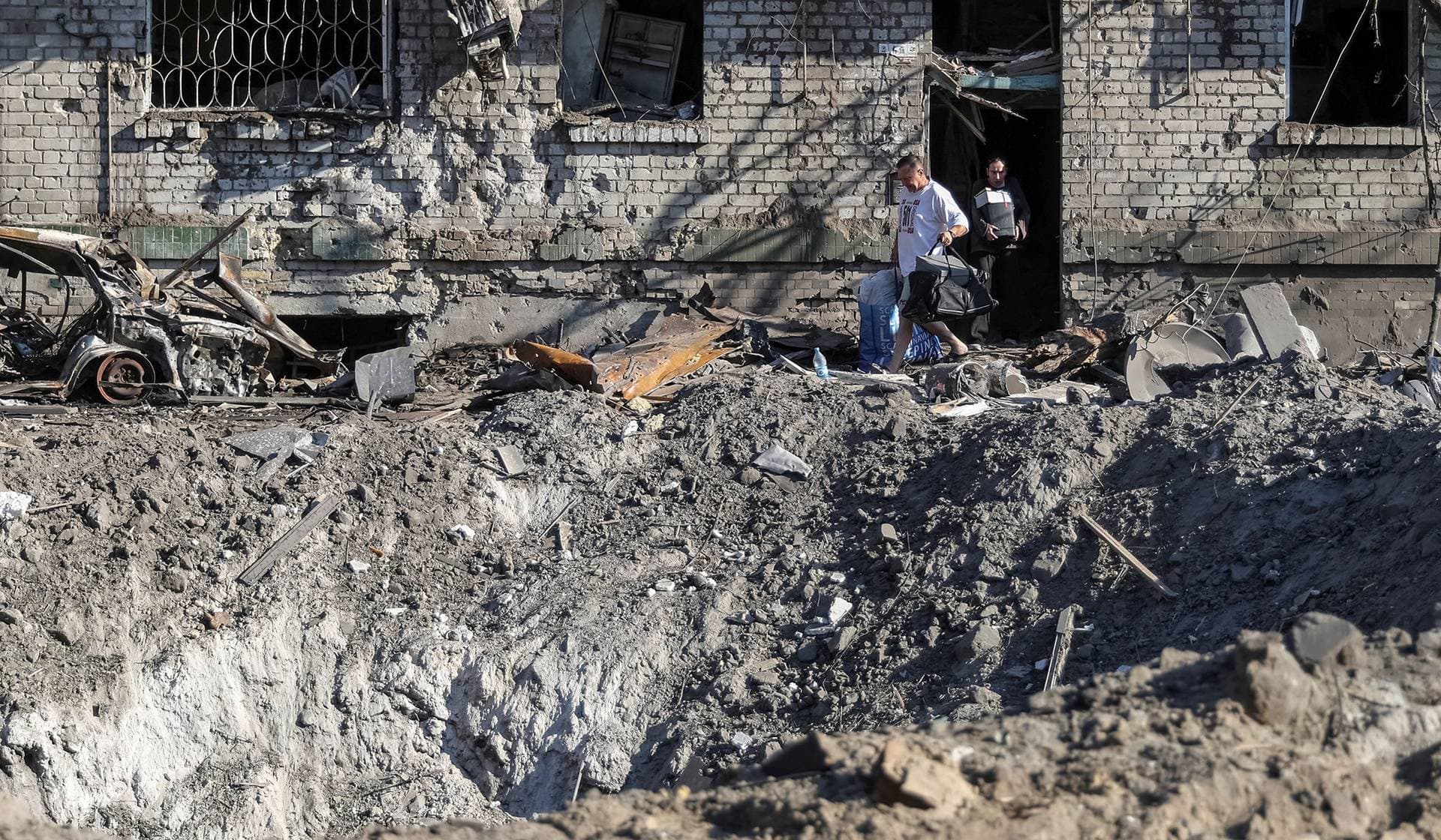 Residents leave an apartment building damaged during a Russian missile and drone strike in Kyiv