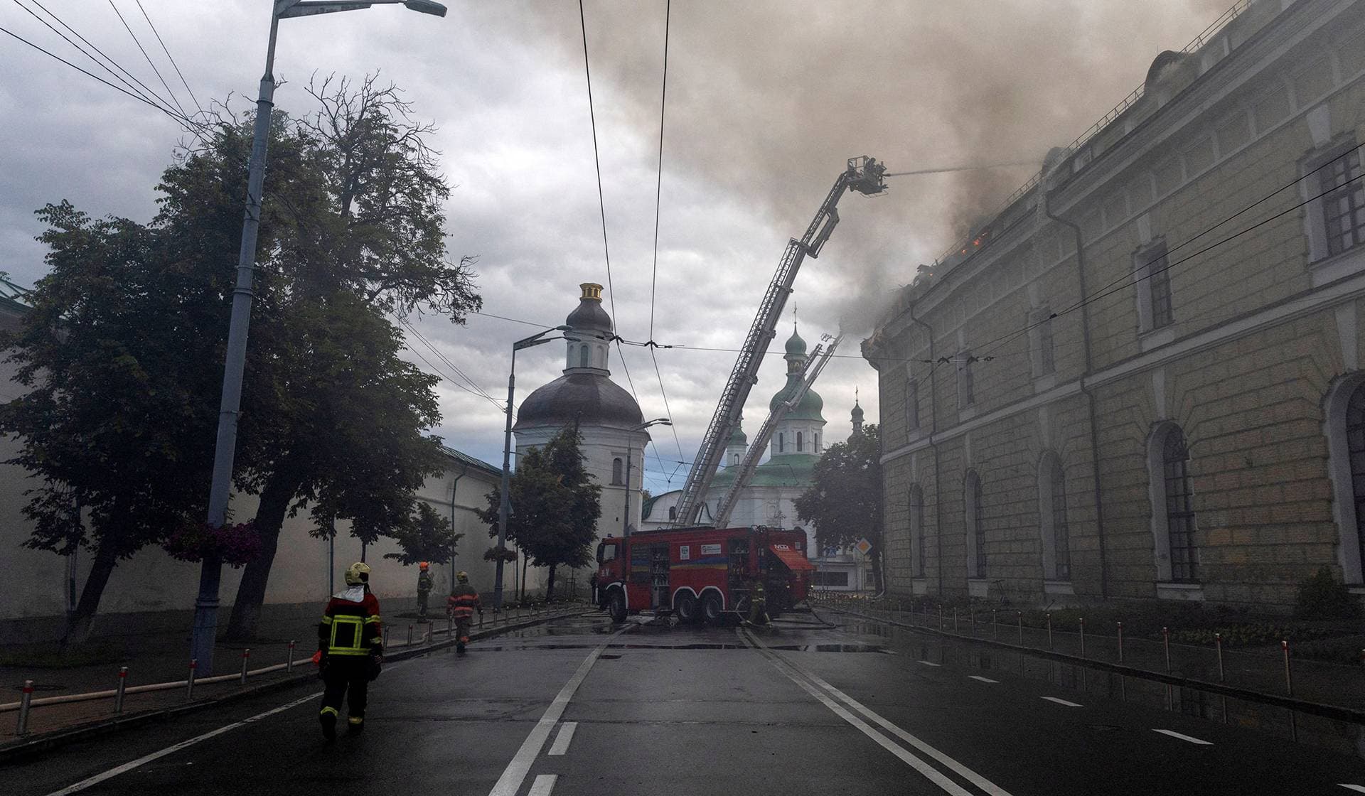Emergency workers extinguish a fire at the Mystetskyi Arsenal National Art and Culture Museum Complex after it was hit during Russian missile and drone strikes in Kyiv