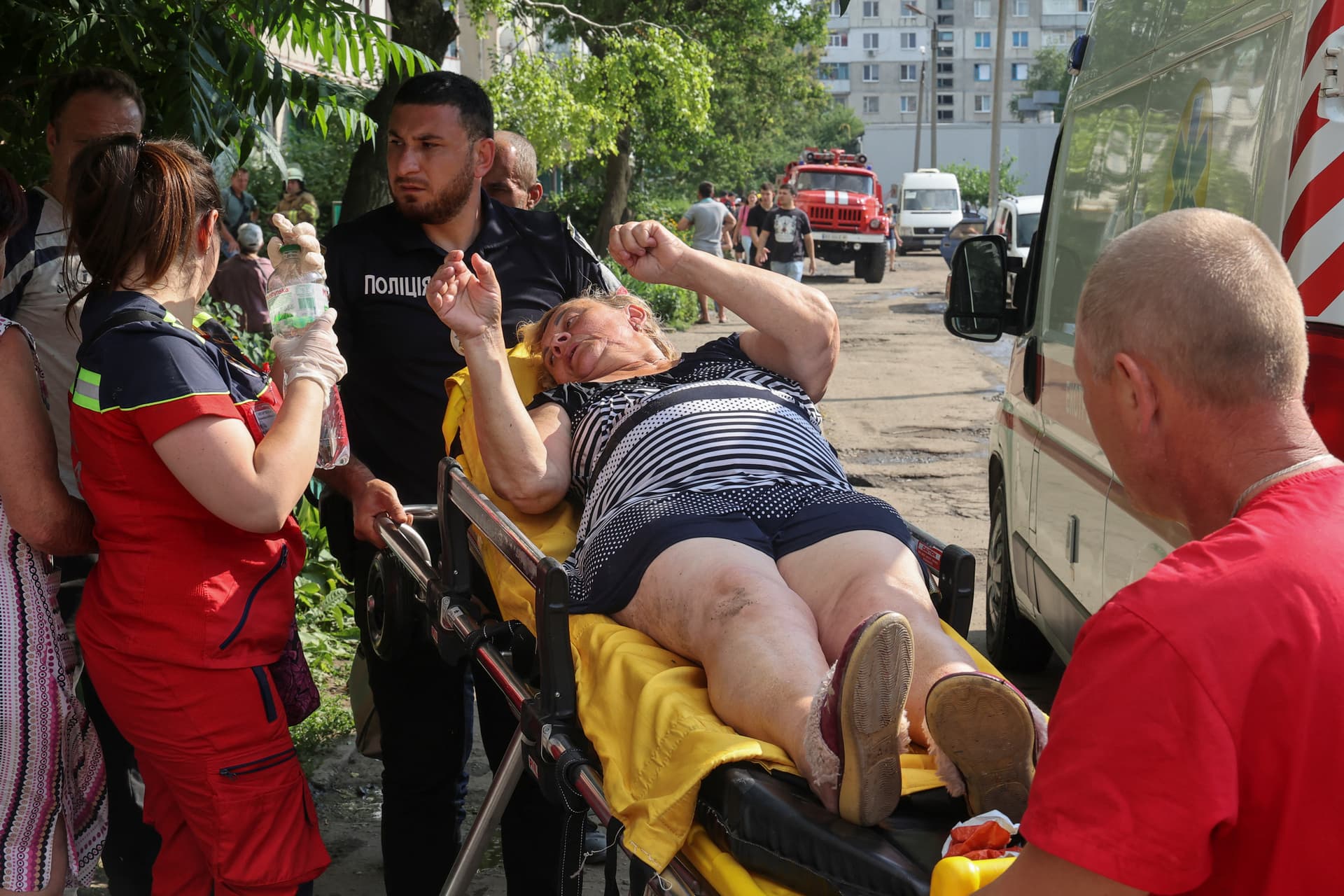 An injured woman is taken away on a stretcher by paramedics in the town of Pervomaiskyi