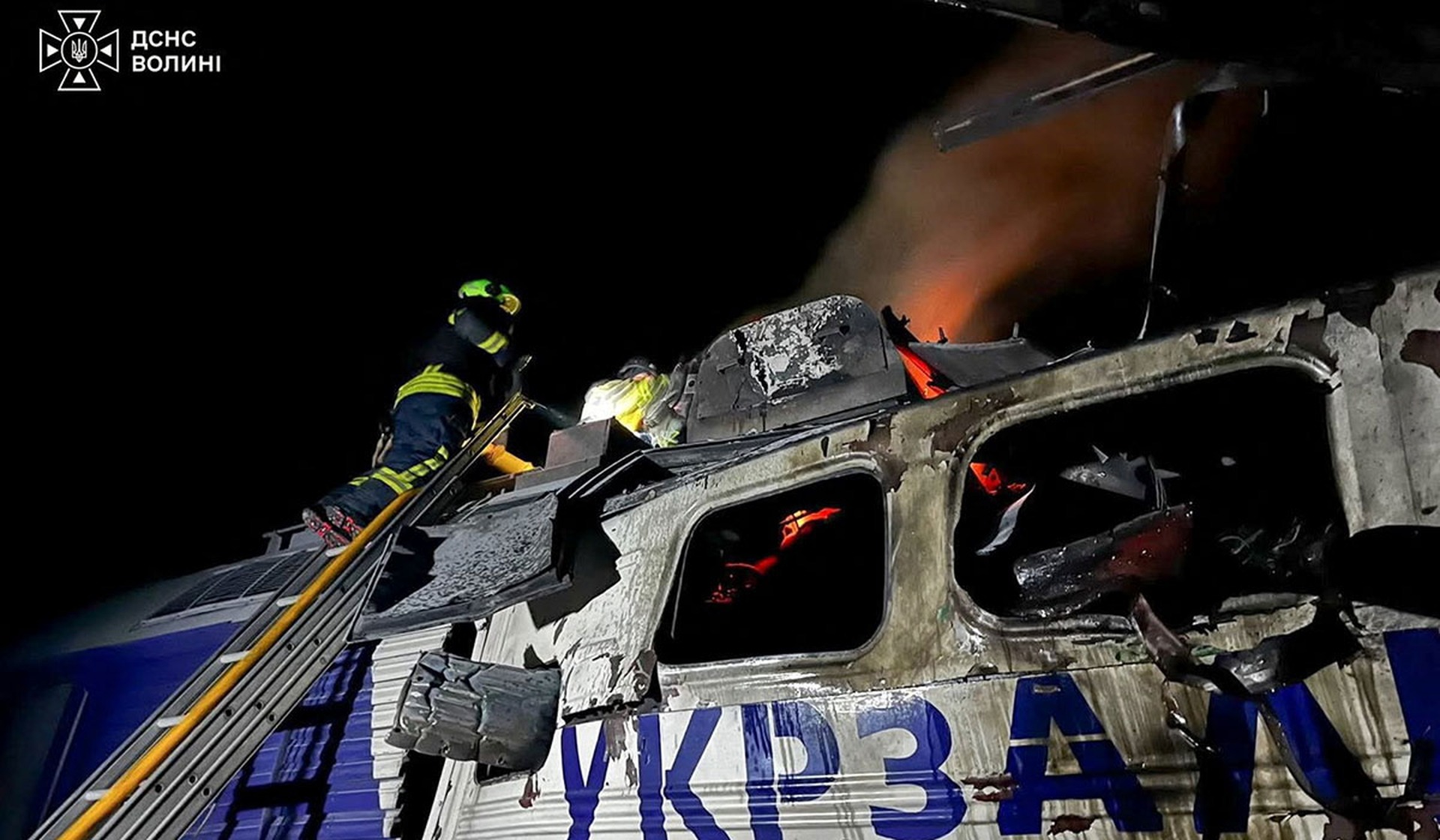Firefighters work at the site of a passenger train locomotive hit by a Russian drone strike in the Volyn Region