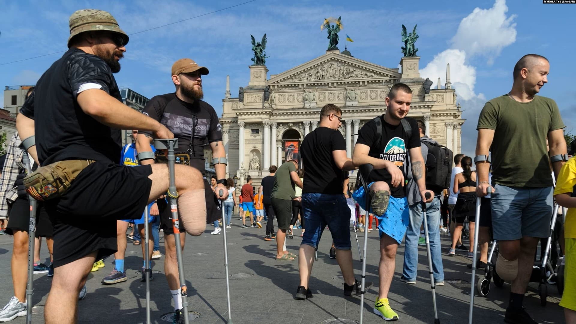 Ukrainian soldiers and civilians who have lost limbs prepare to take part in a charity half-marathon in downtown Lviv