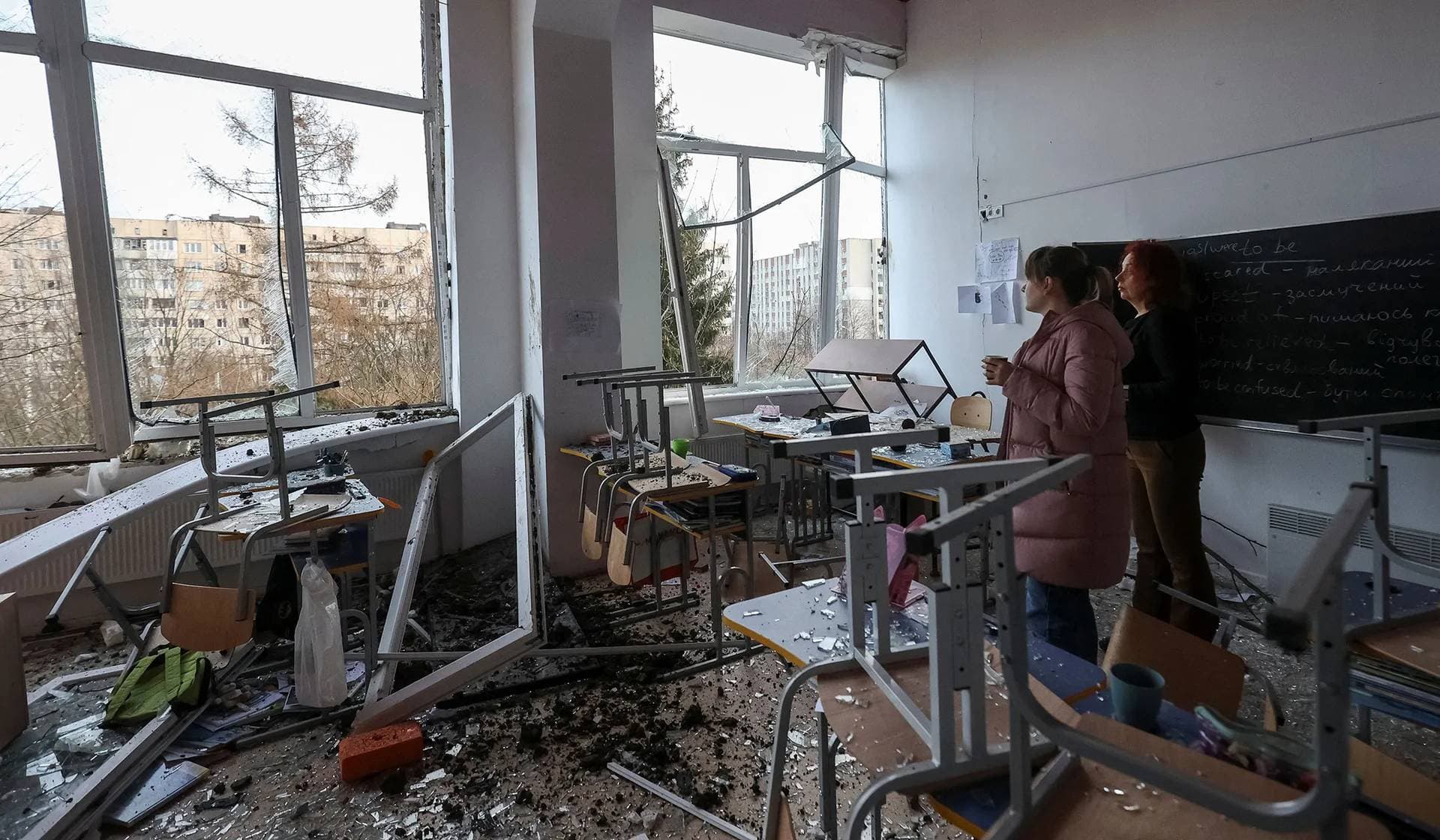 People stand inside a school destroyed during a Russian missile strike in Lviv