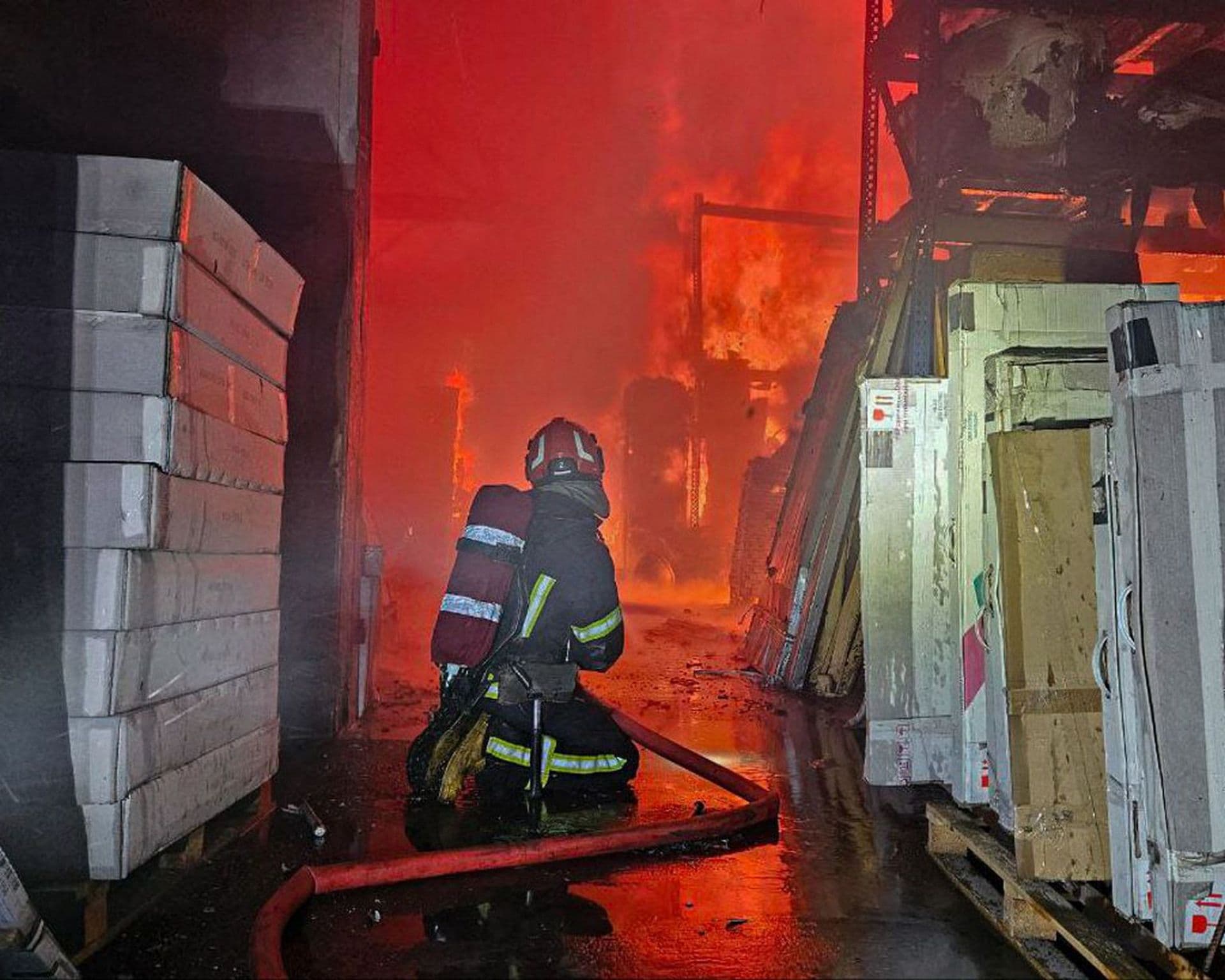 emergency services personnel work to extinguish a fire following a Russian attack in Lviv