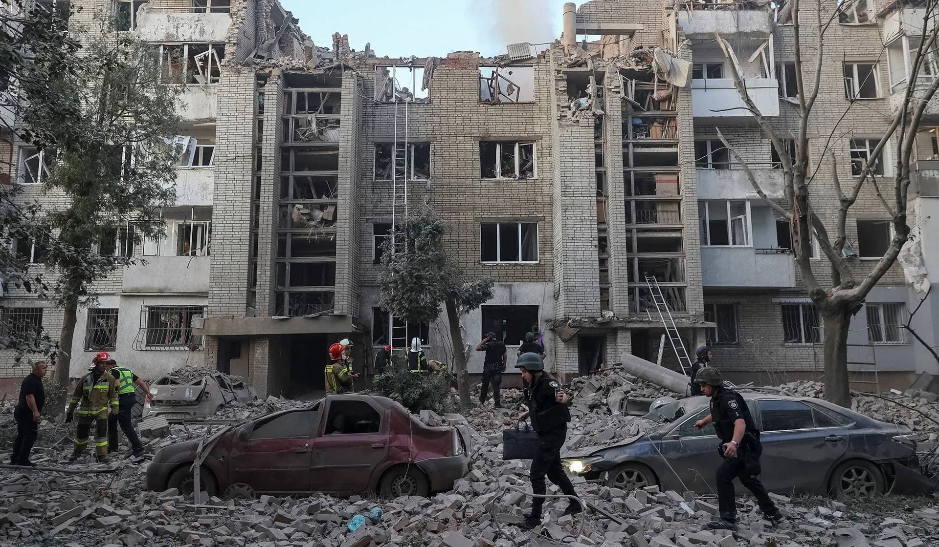 Rescuers work at the site of an apartment building hit by a Russian missile strike in Lviv