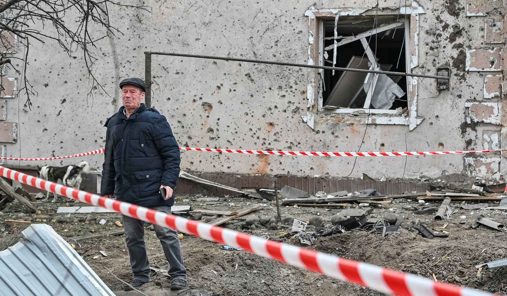 A man stands at a site of a private house hit by a Russian drone strike on the outskirts of Lviv