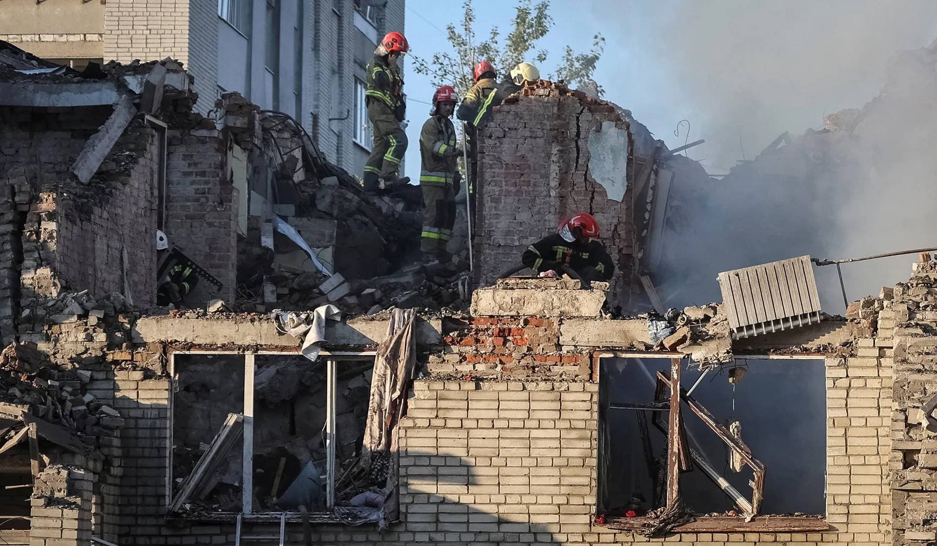 Rescuers work at the site of an apartment building hit by a Russian missile strike in Lviv