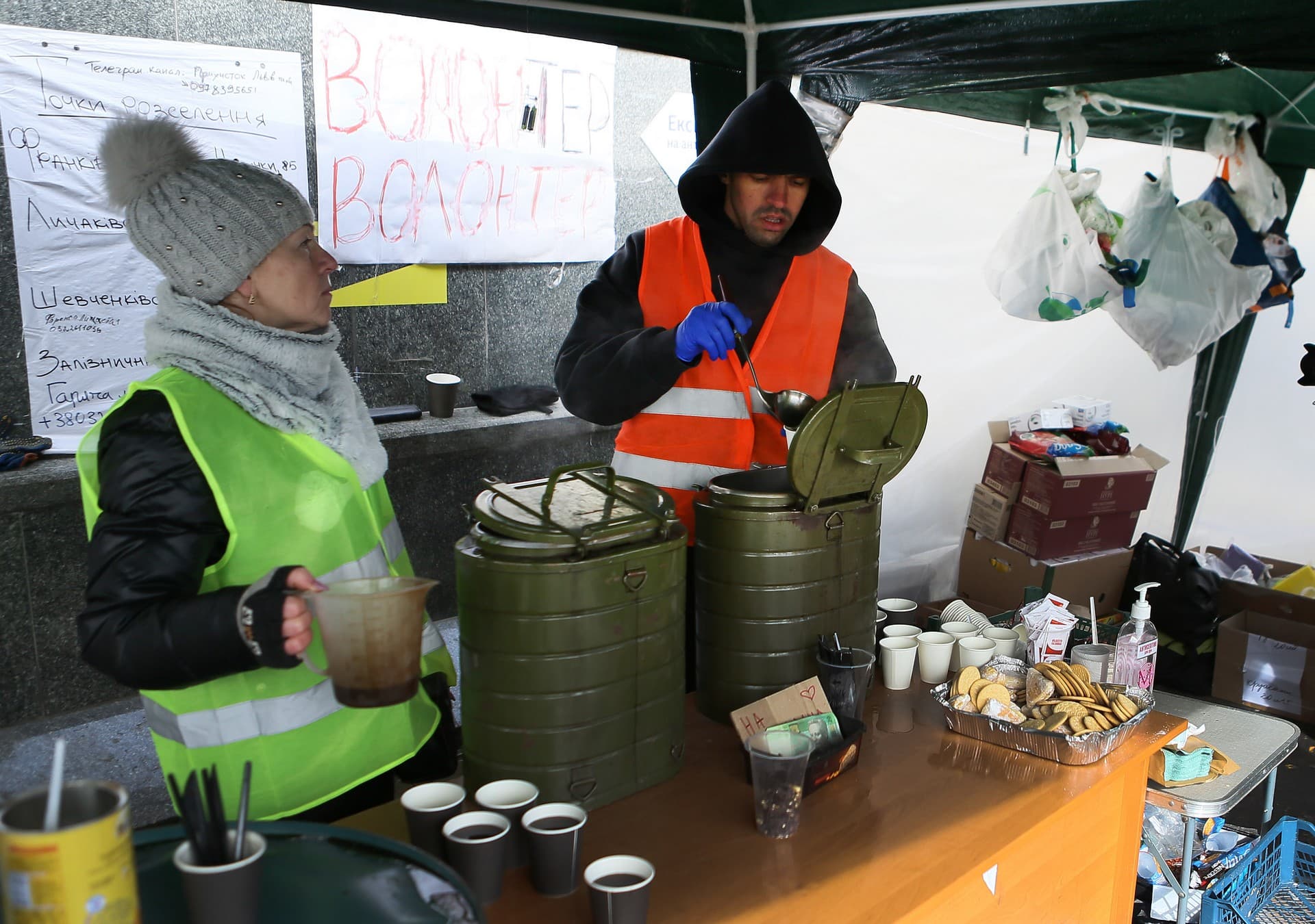 Volunteers distribute hot drinks at the refugee center in Lviv
