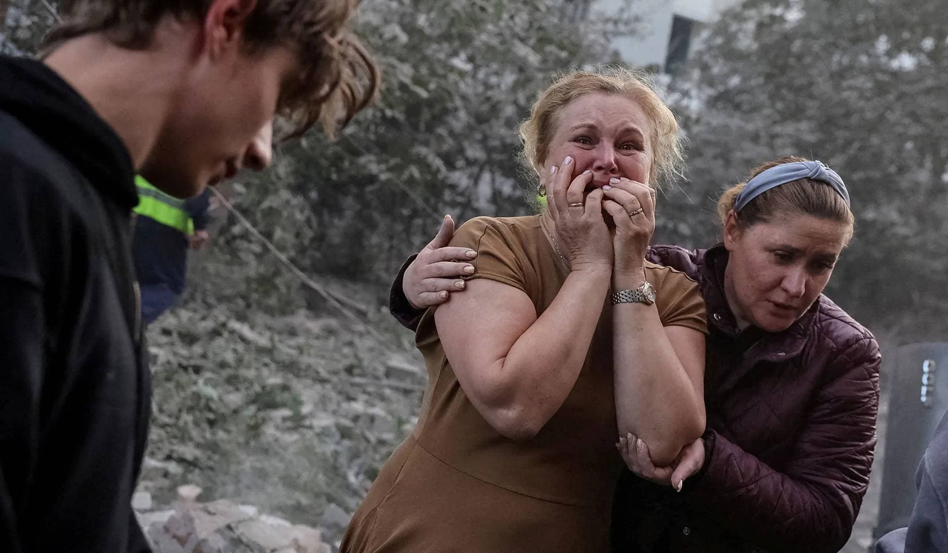 A woman reacts near an apartment building hit by a Russian missile strike in Lviv