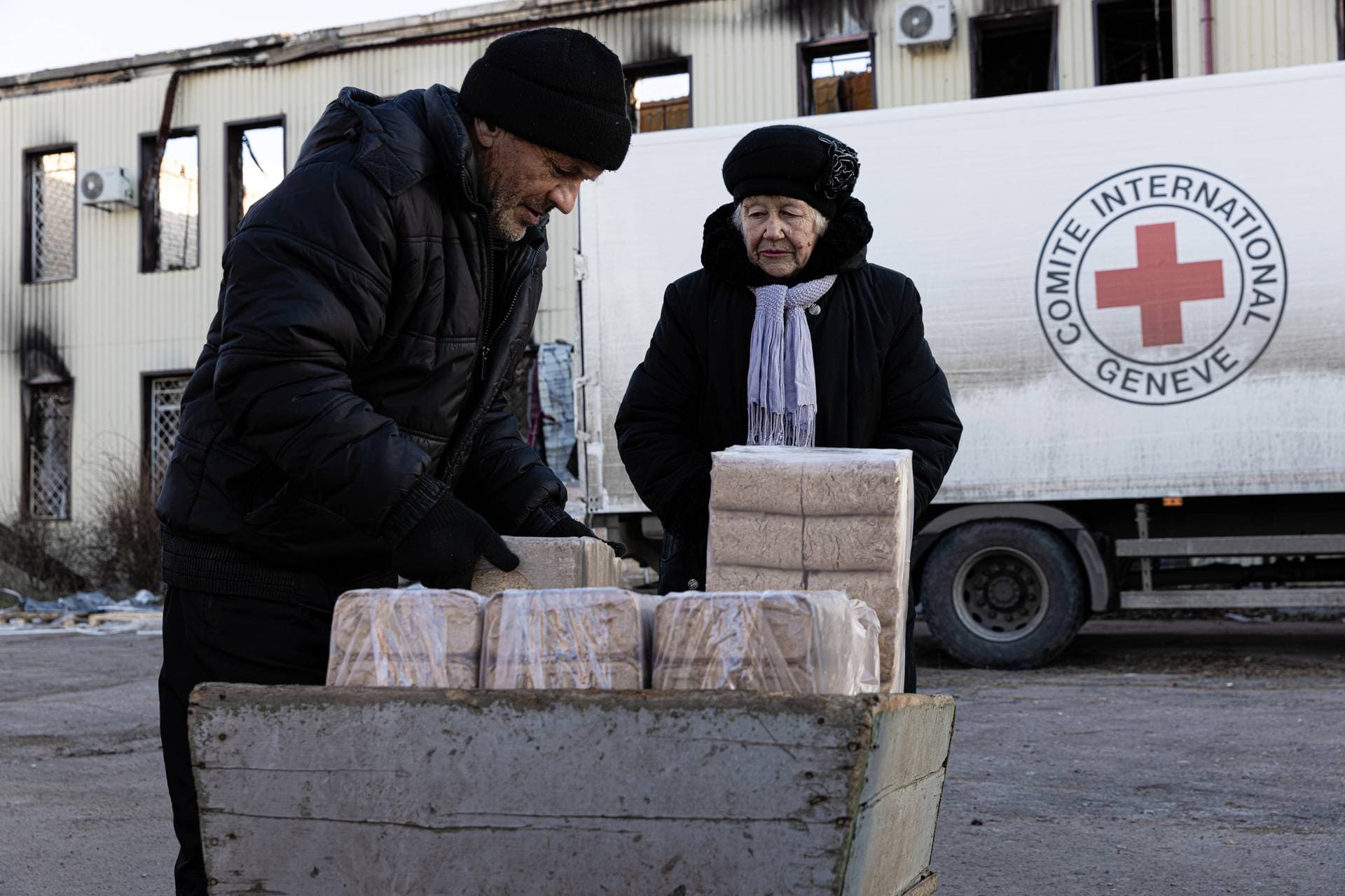 The Red Cross distributes dry fuel bricks in Lyman after mines and unexploded munitions have made collecting firewood a serious challenge