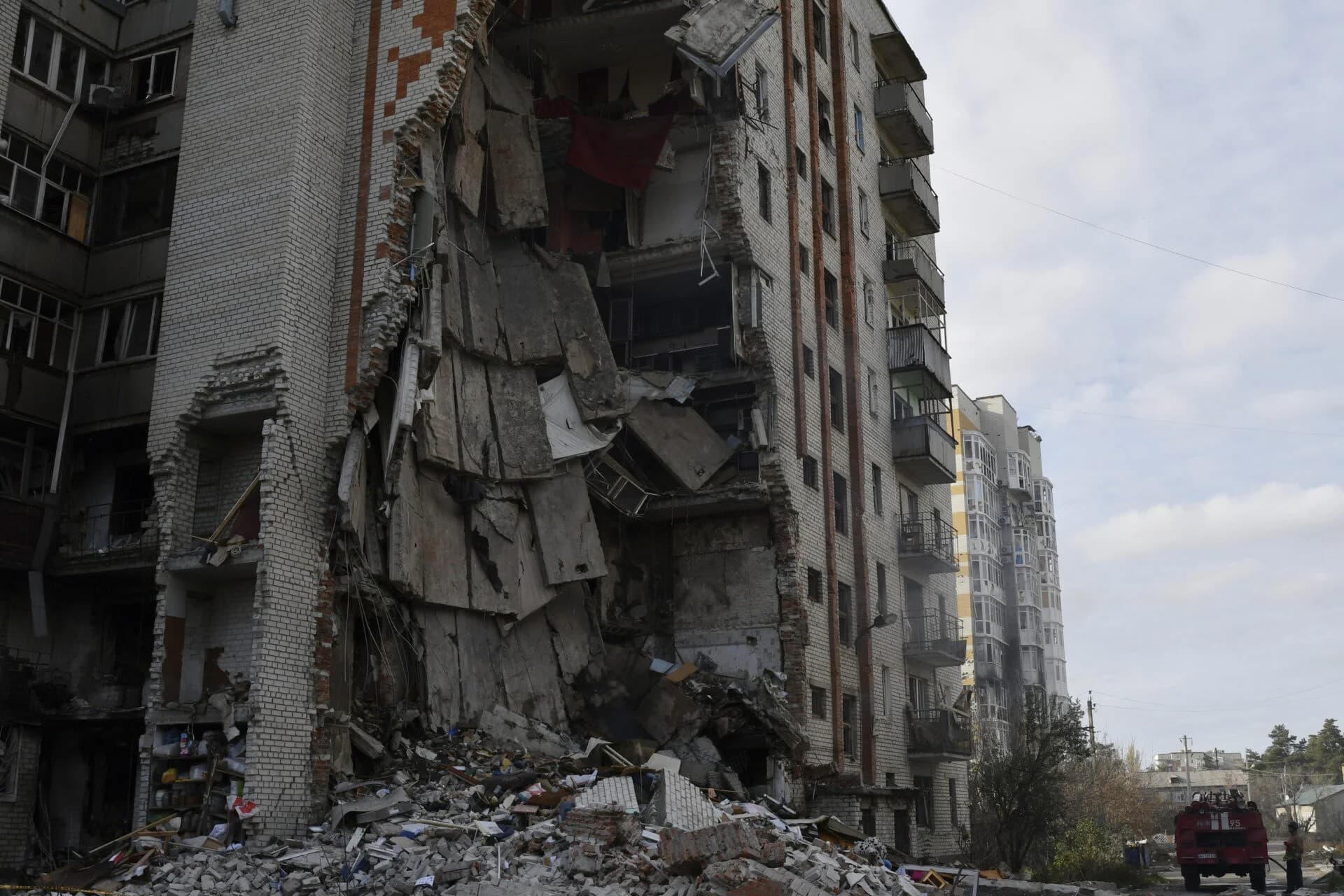 Firefighters work at the scene of a damaged residential building after Russian shelling in the liberated Lyman