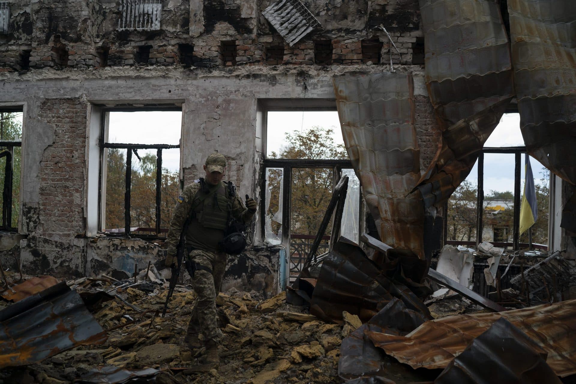A Ukrainian serviceman walks over debris in a heavily damaged school at the recaptured town of Lyman